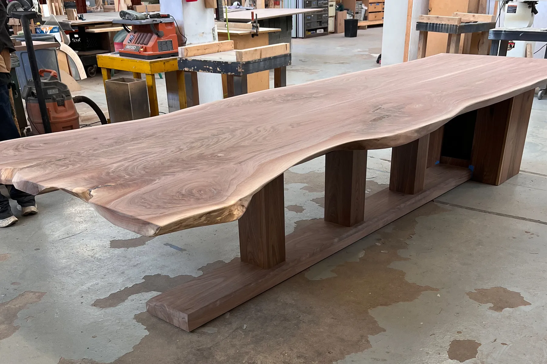 Custom walnut live edge conference table by Icon Modern