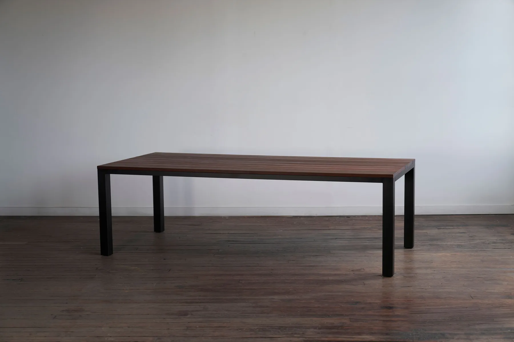 custom outdoor conference table in ipe wood and steel post base by Icon Modern