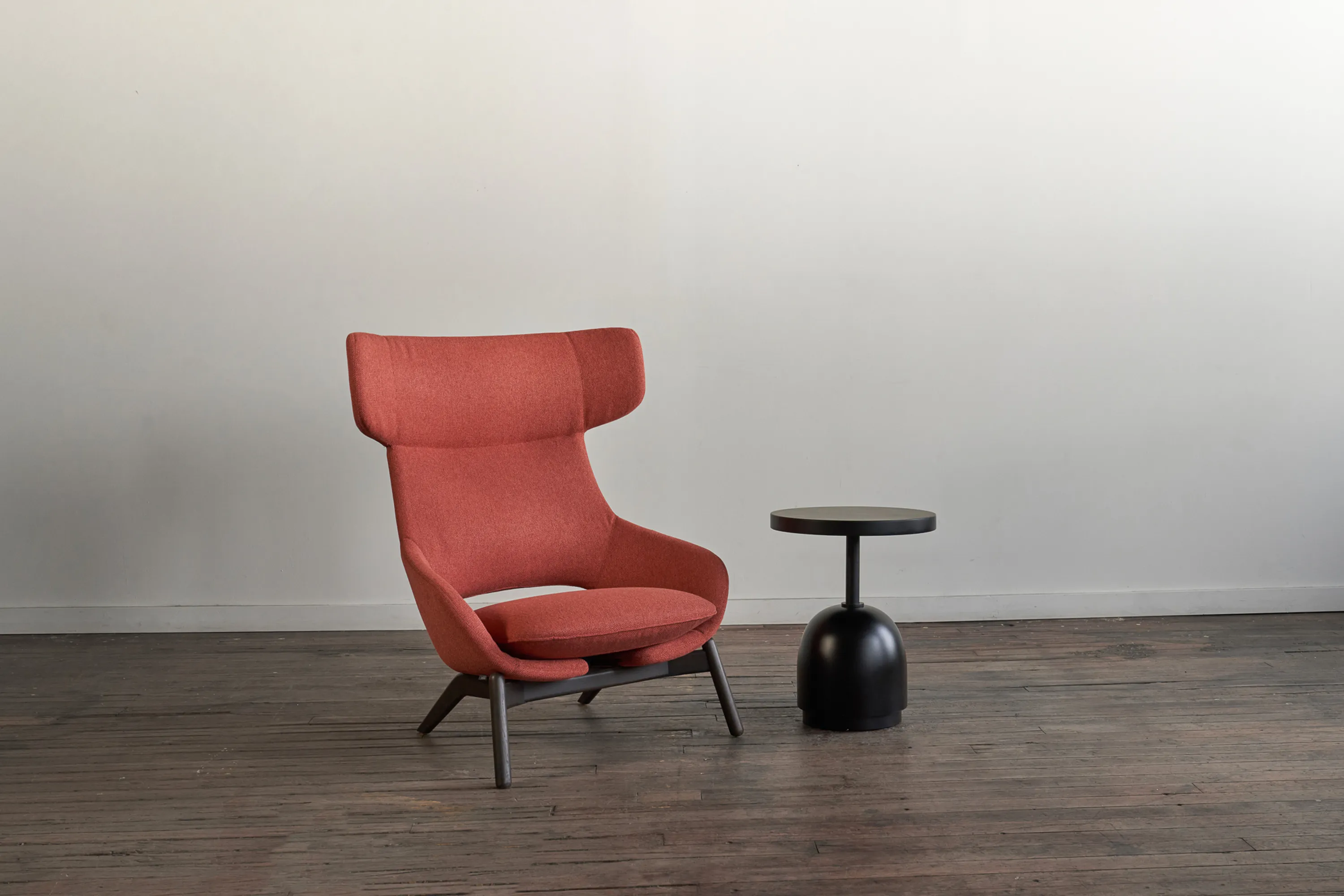custom side table featuring ebonized maple wood with turned base and steel support by Icon Modern