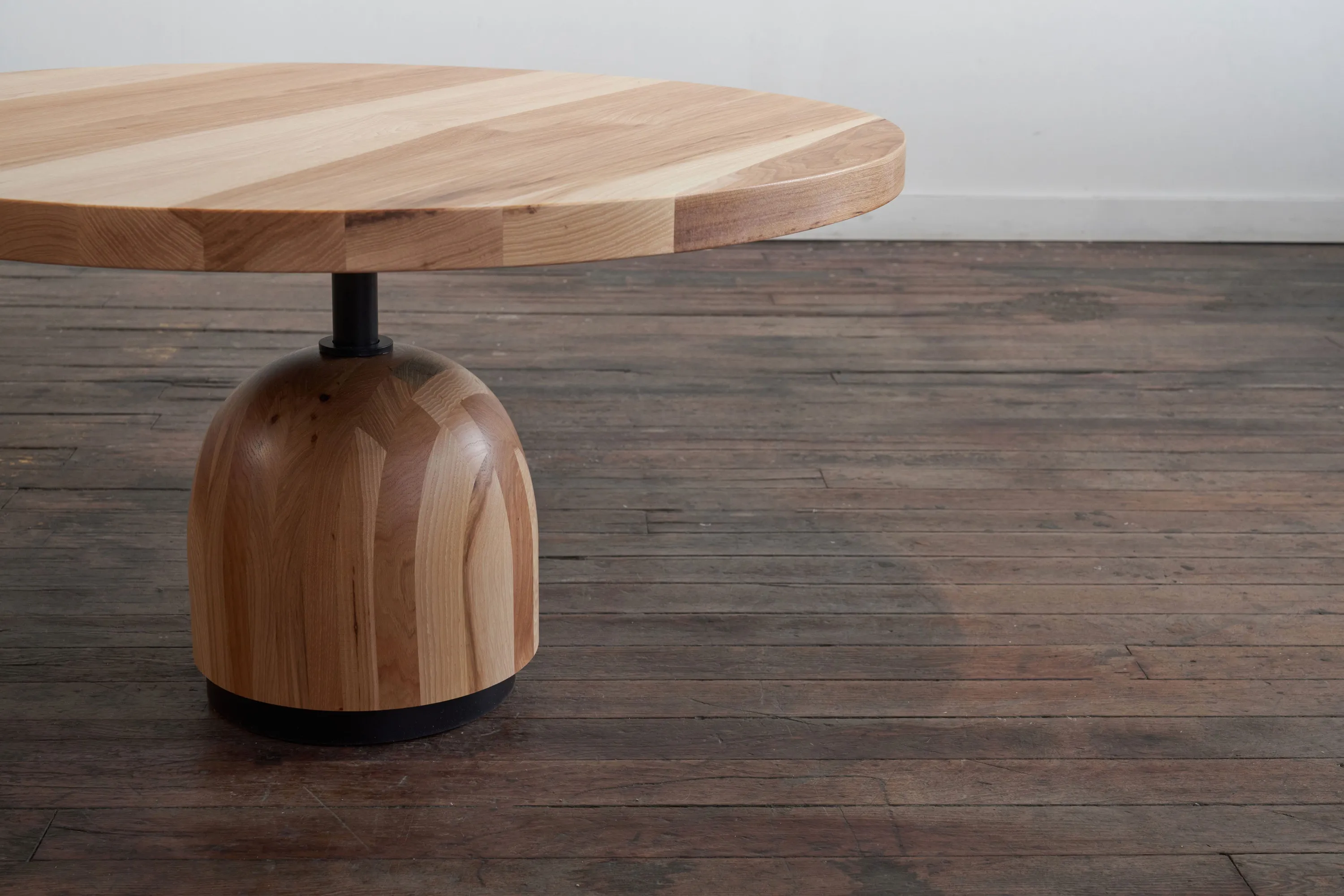 custom hickory coffee table with turned base and steel support by Icon Modern