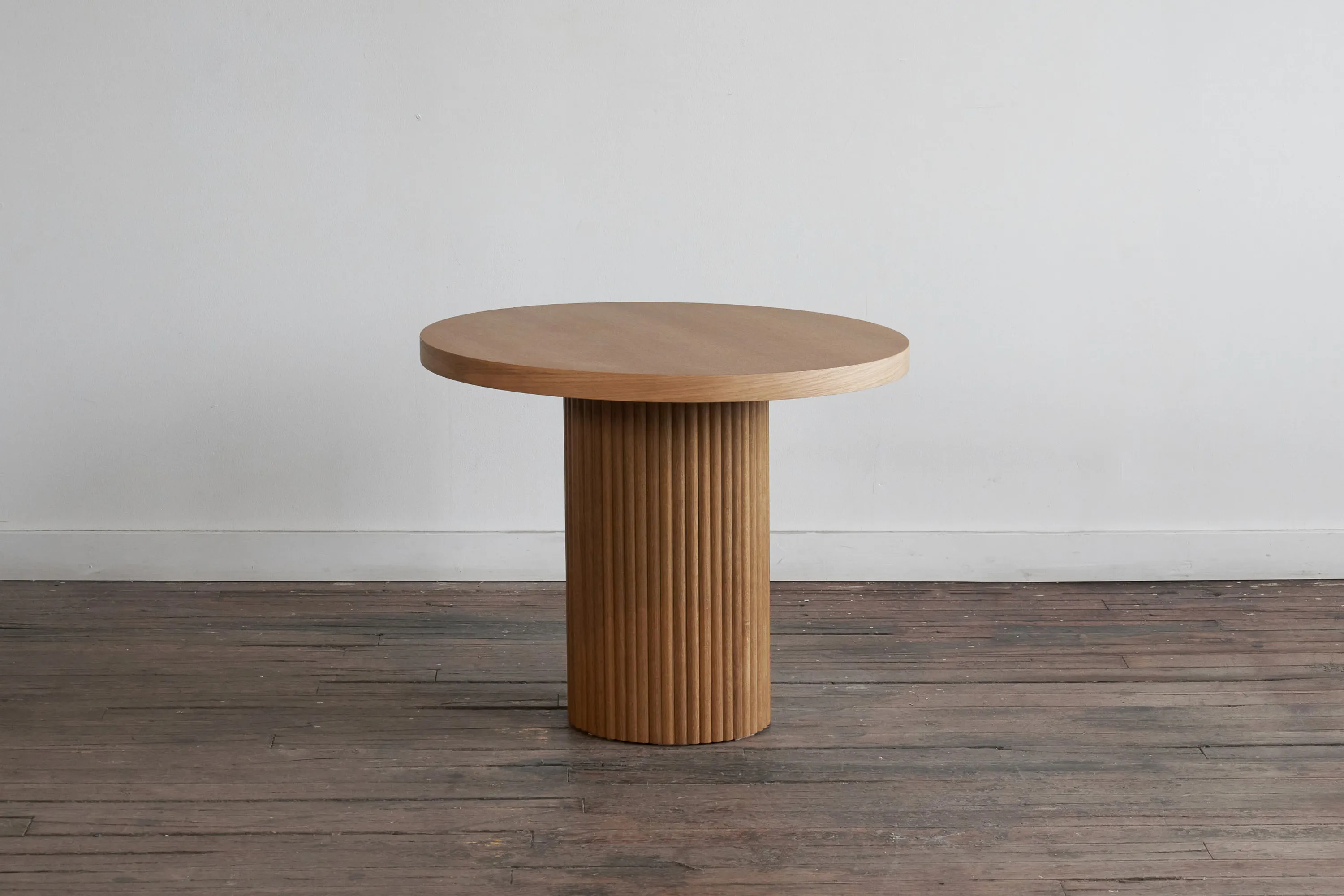 custom cafe table in urban oak with a tambour base by Icon Modern