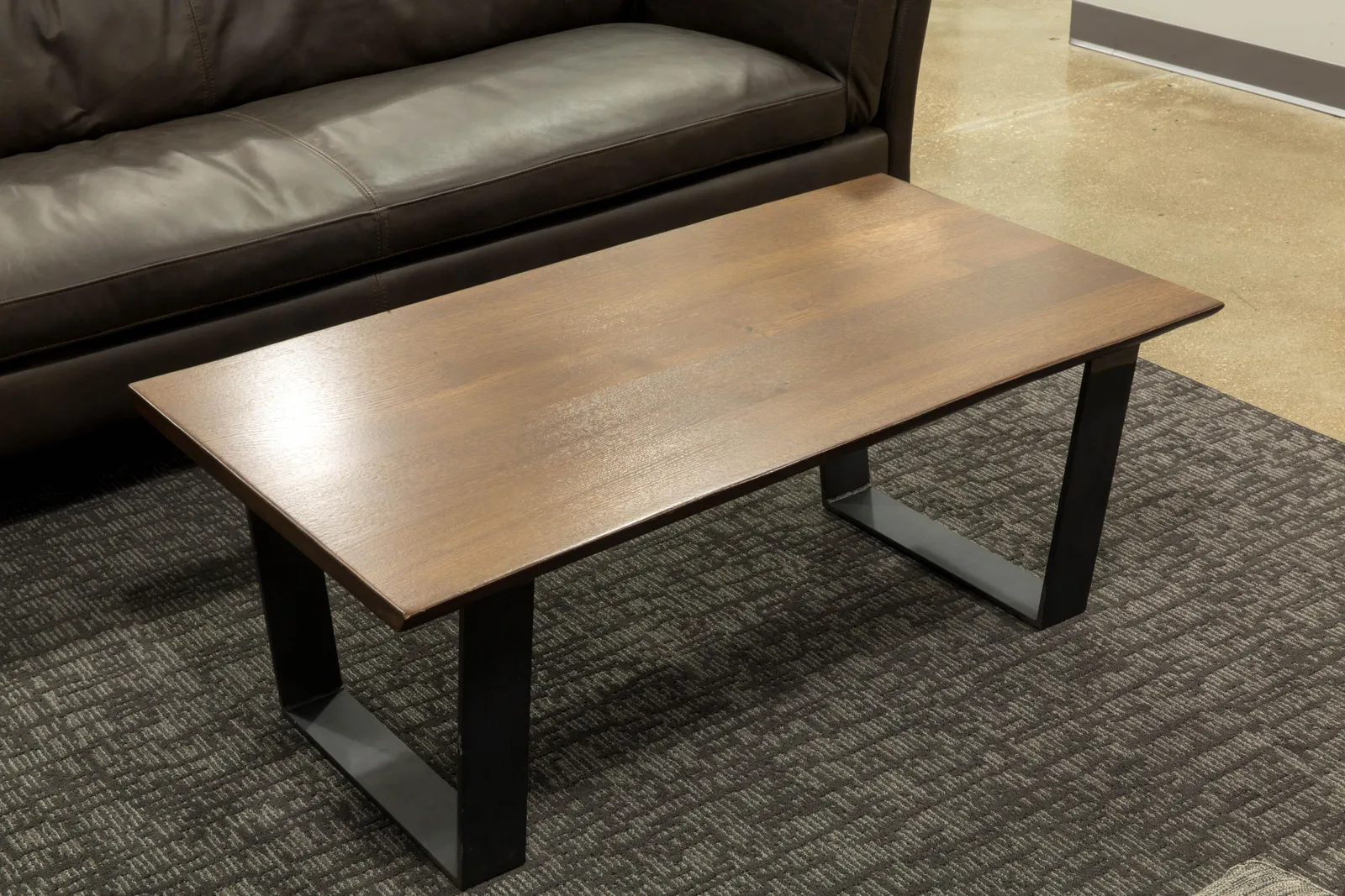 Custom coffee table walnut top steel trapezoid base by icon modern