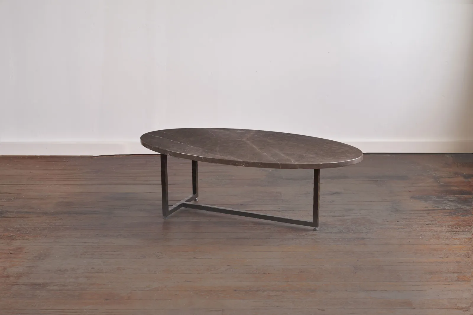 Custom oval coffee table brown marble steel base by icon modern