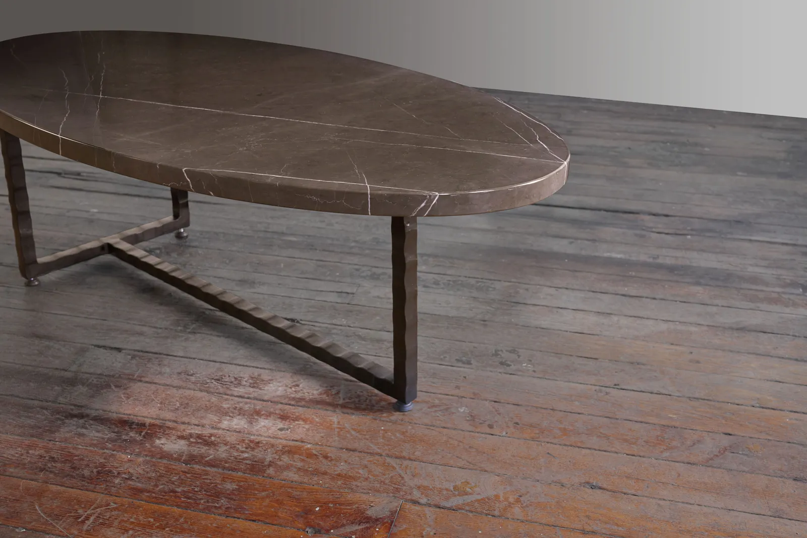 Custom oval coffee table brown marble steel base by icon modern