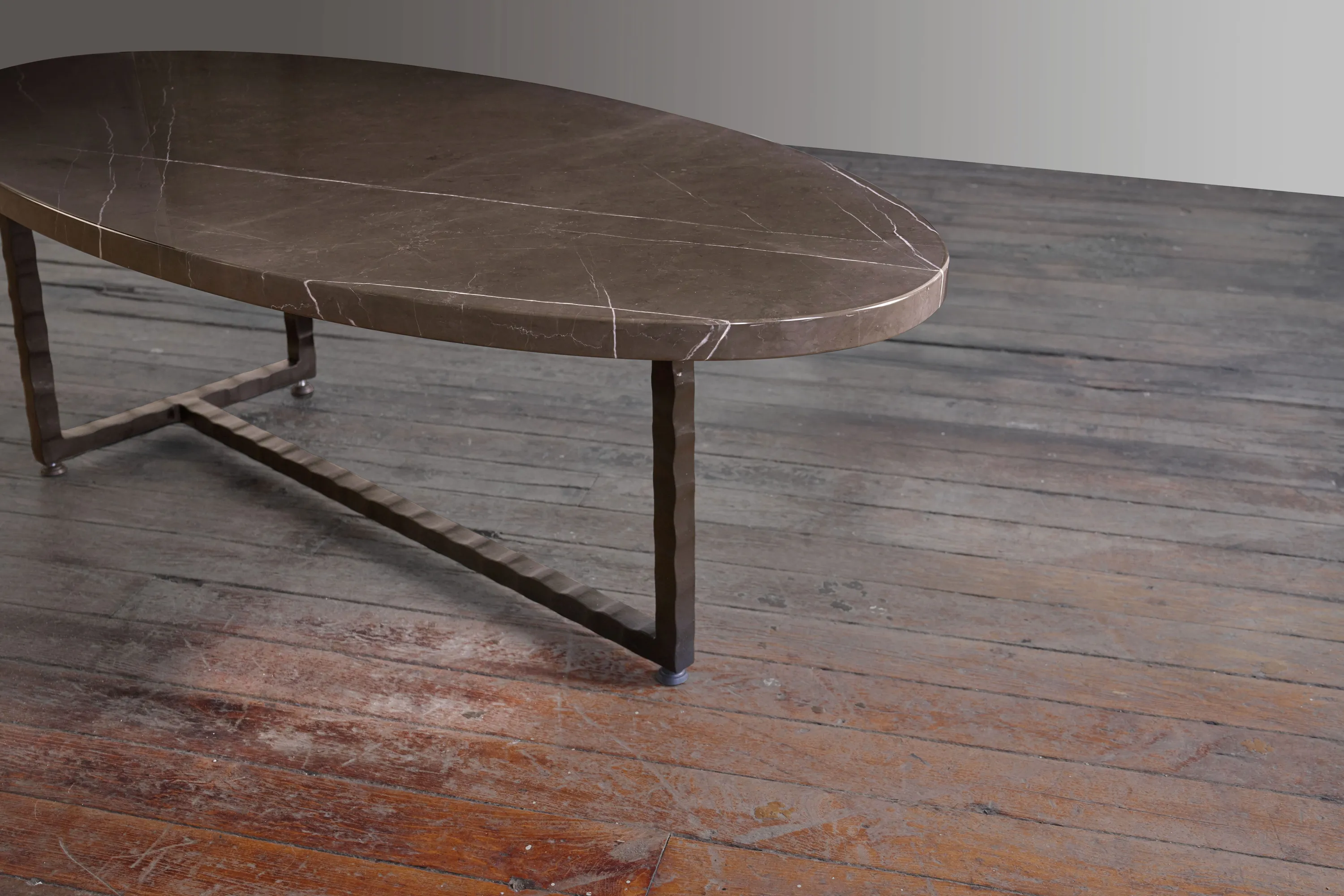 Custom oval coffee table brown marble steel base by icon modern