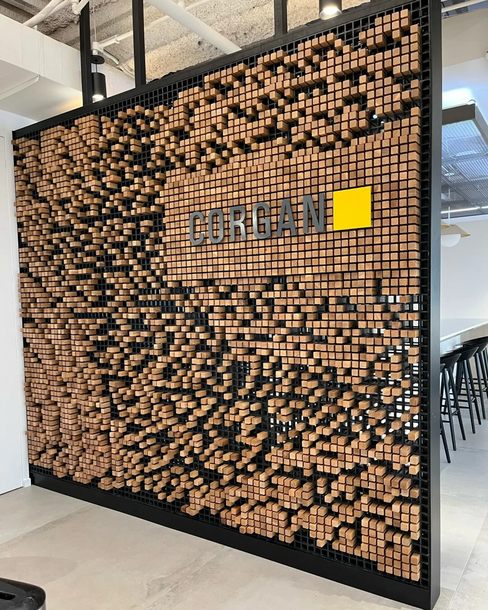 custom space divider with signage and wooden peg grid by Icon Modern