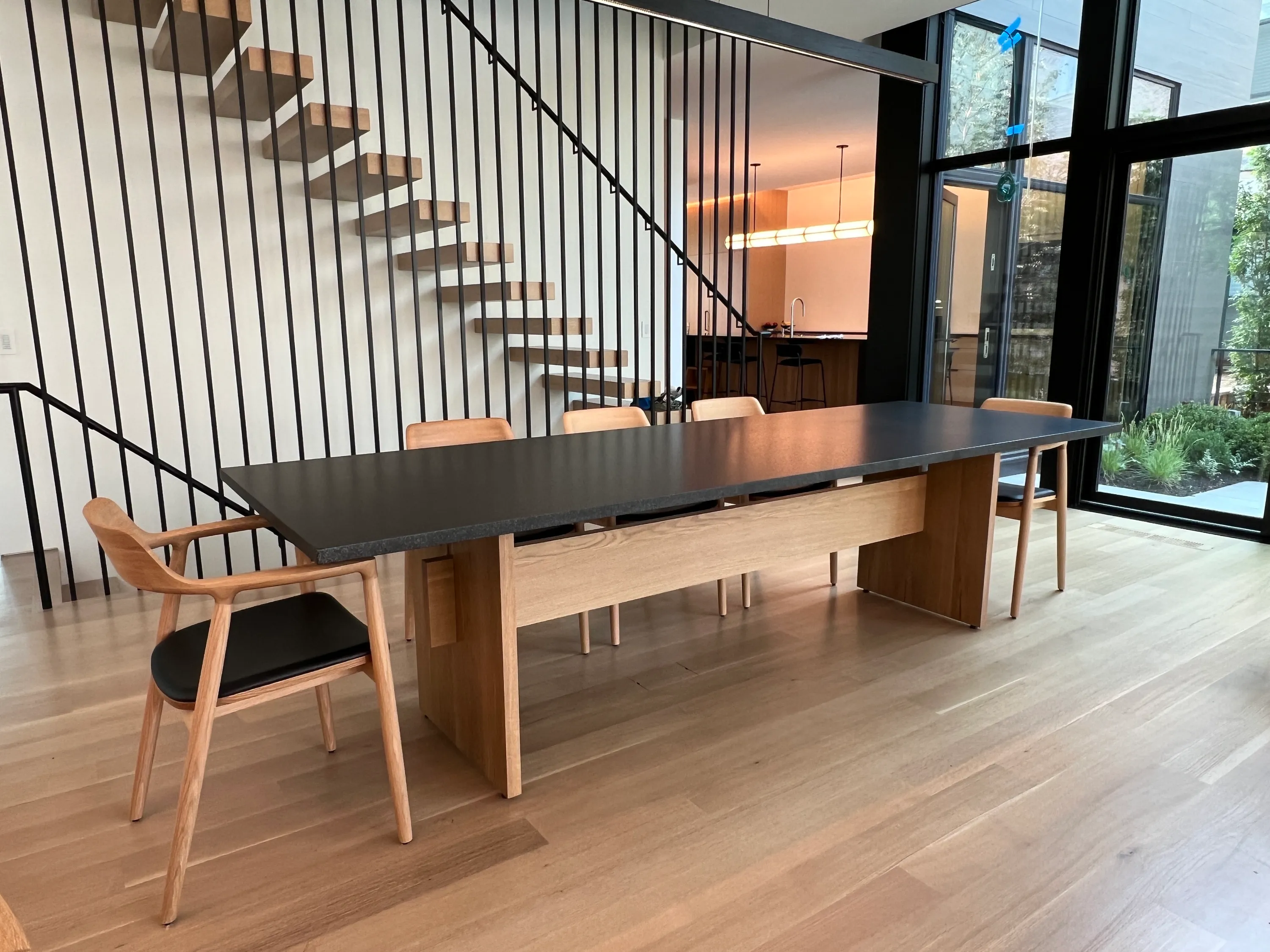 custom table with stone top and walnut panel base by Icon Modern