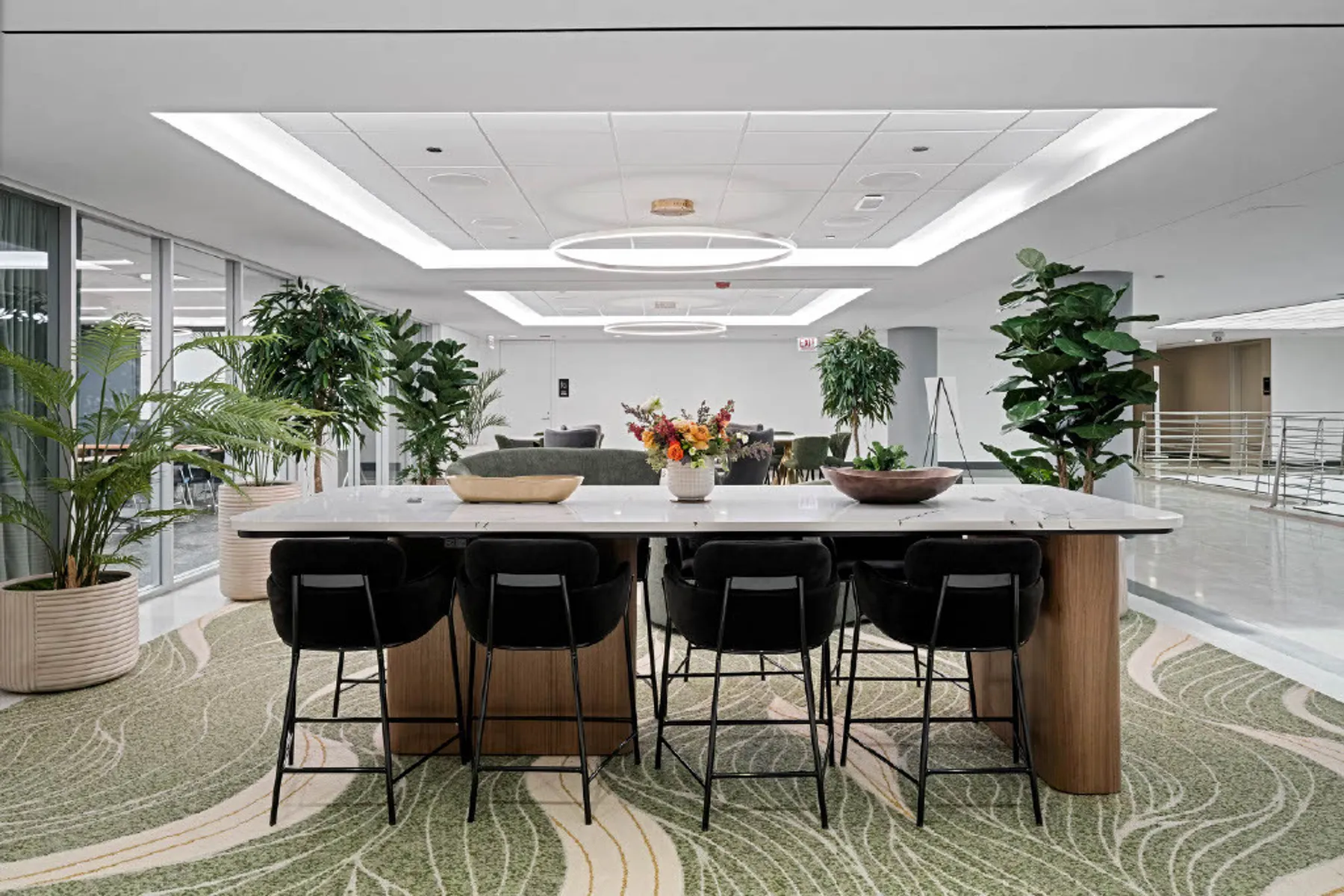 custom stone table with curved walnut veneer panel legs by Icon Modern