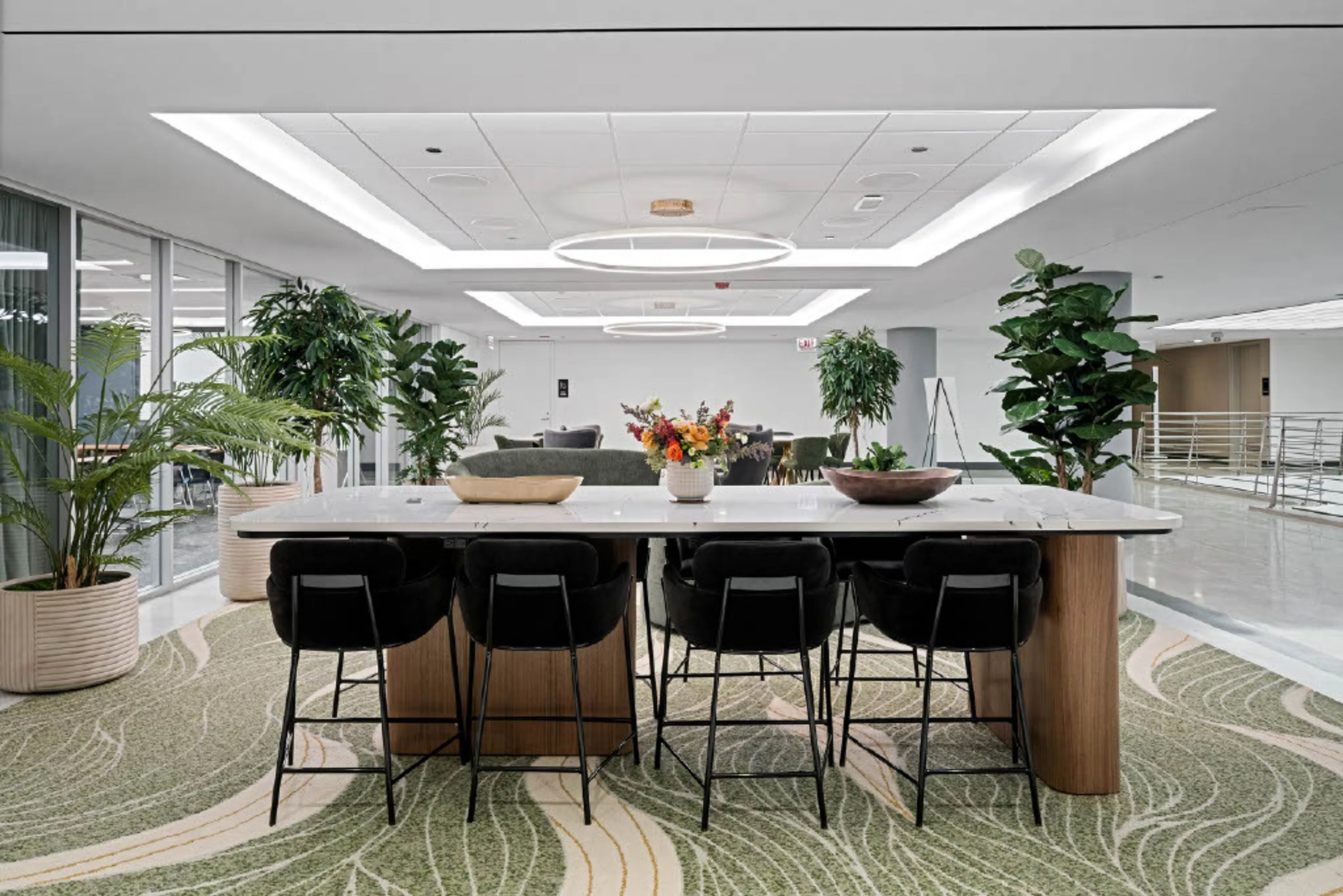 custom stone table with curved walnut veneer panel legs by Icon Modern