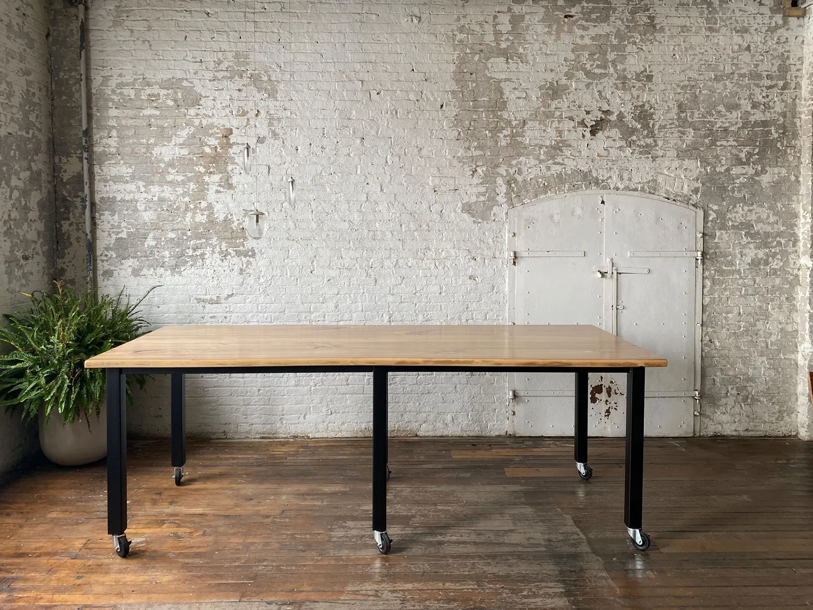 custom community table in urban ash with casters by Icon Modern