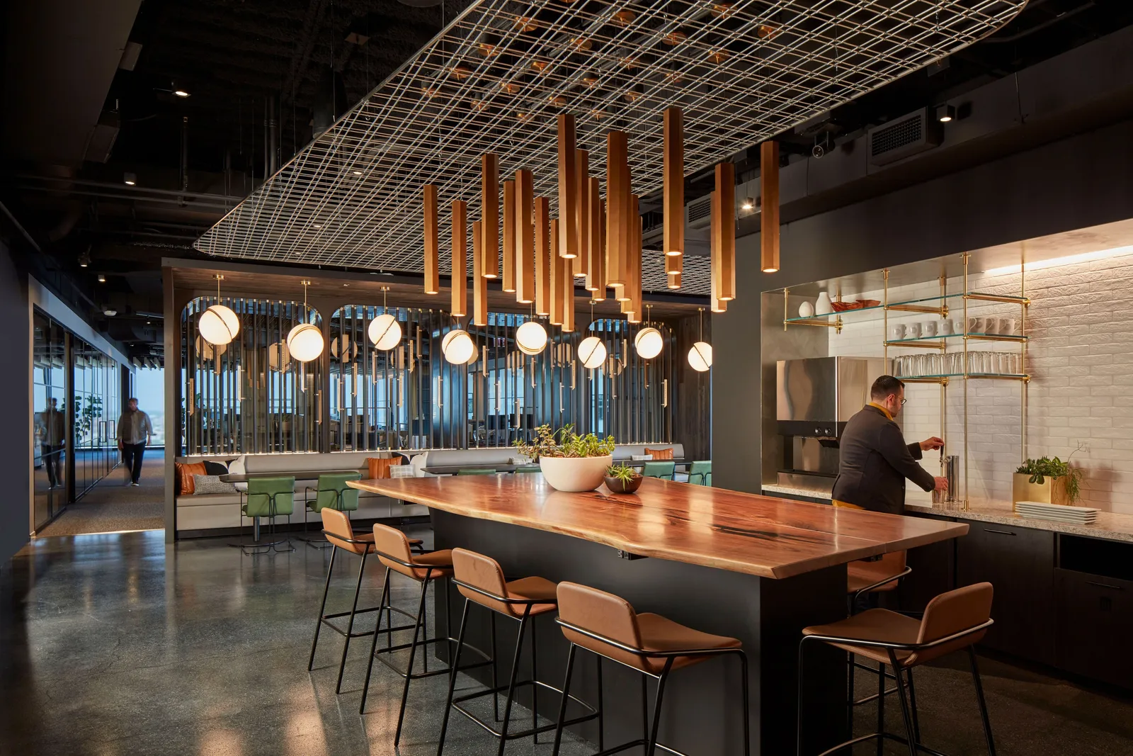 custom community table in urban walnut with brass shelving by Icon Modern