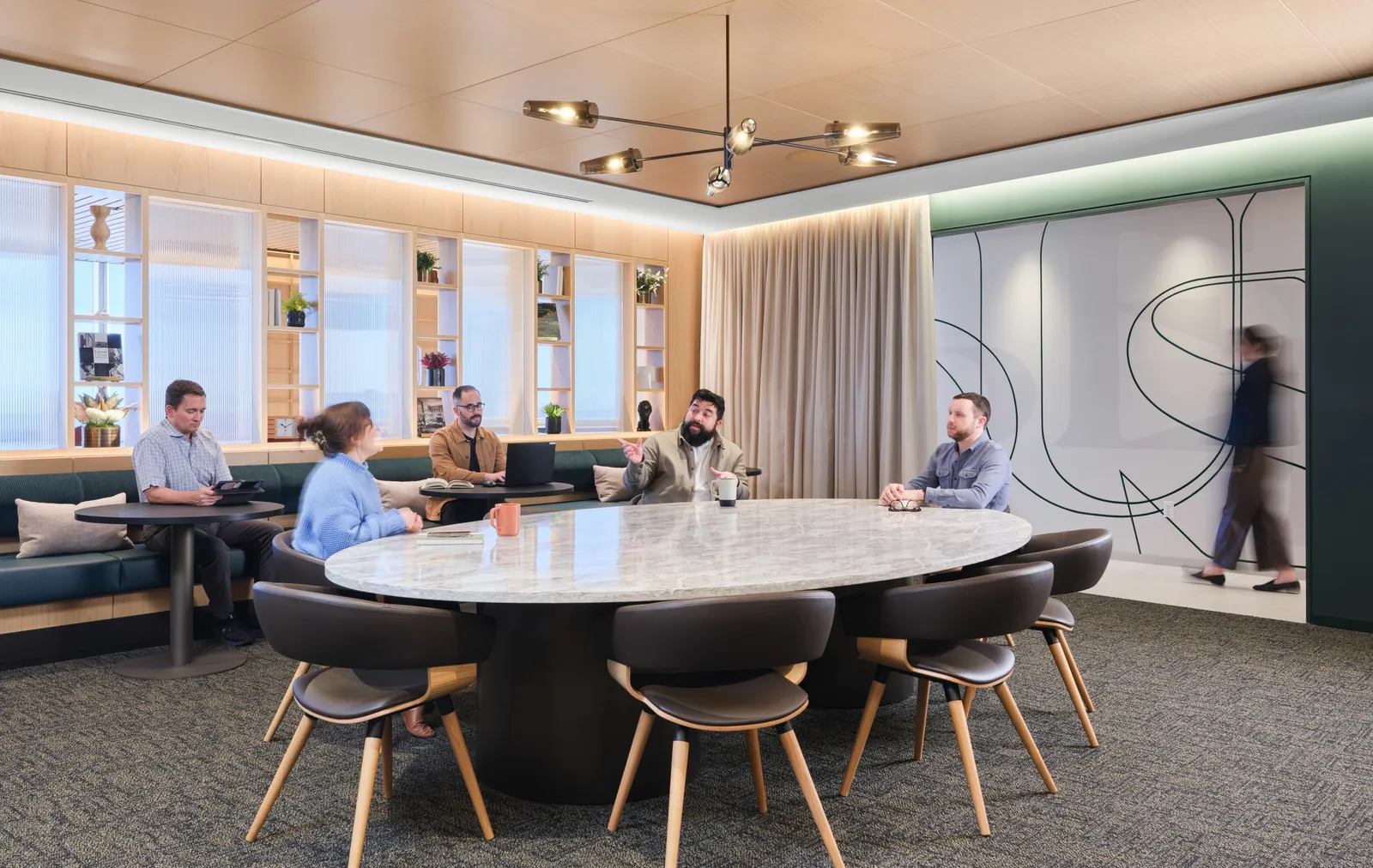 custom stone conference table with steel drum bases and bronze color powdercoat by Icon Modern