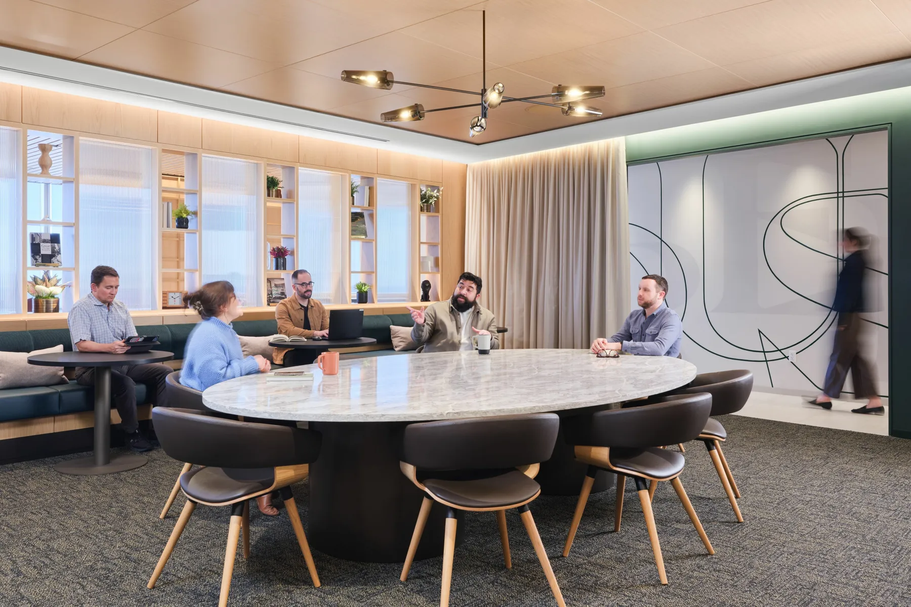 custom stone conference table with steel drum bases and bronze color powdercoat by Icon Modern