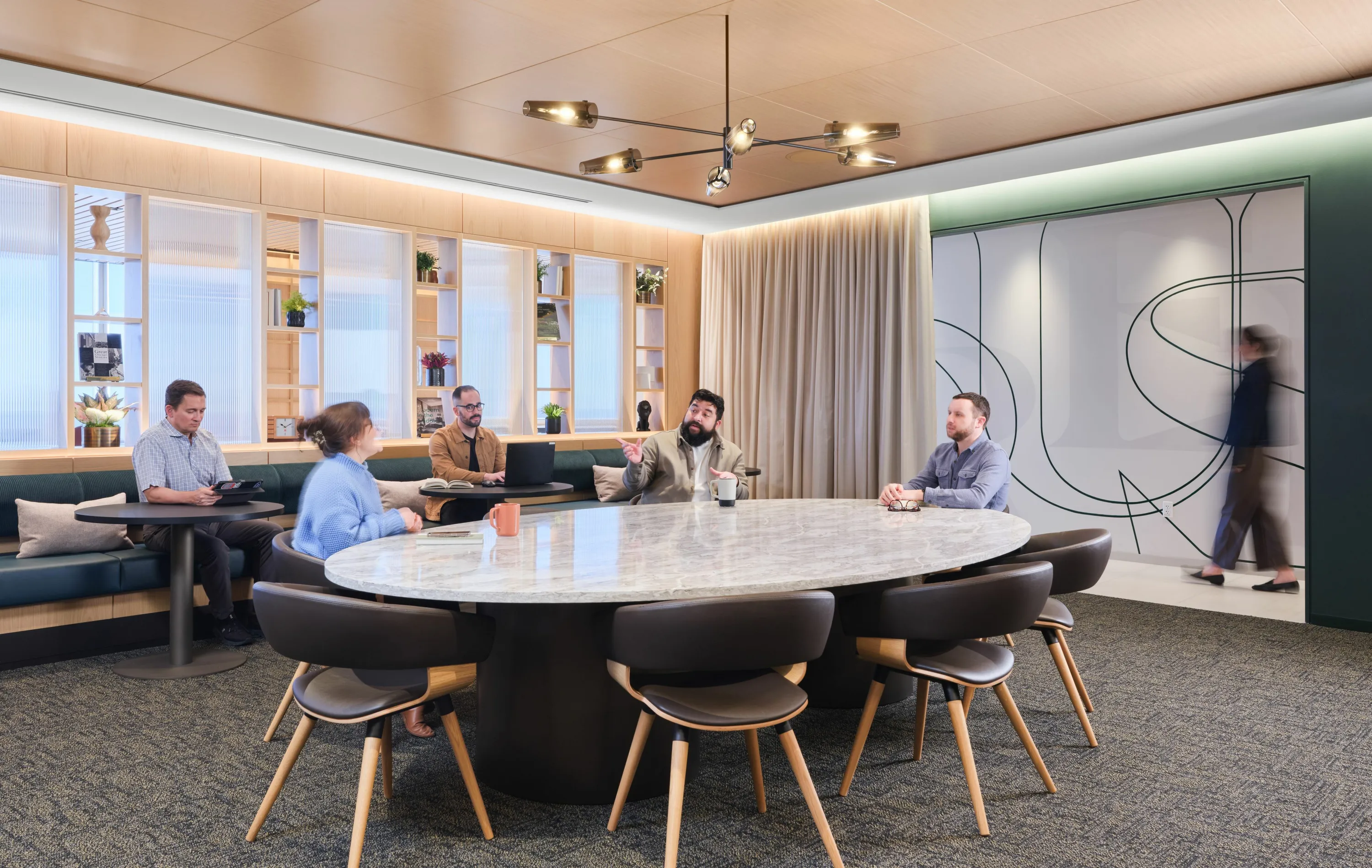 custom stone conference table with steel drum bases and bronze color powdercoat by Icon Modern