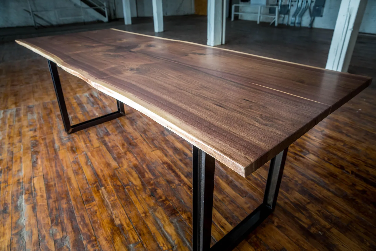 Custom live edge walnut conference table strap ibeam base by icon modern
