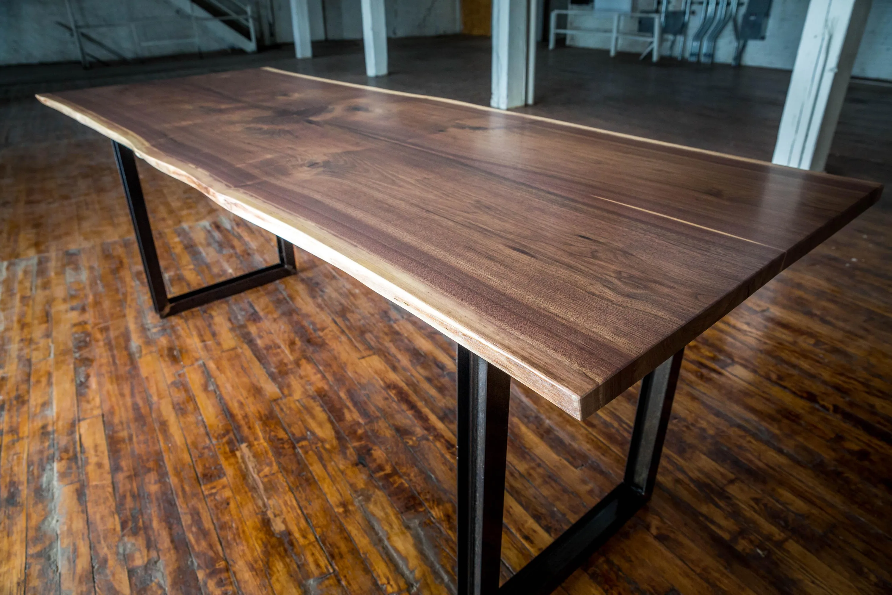 Custom live edge walnut conference table strap ibeam base by icon modern