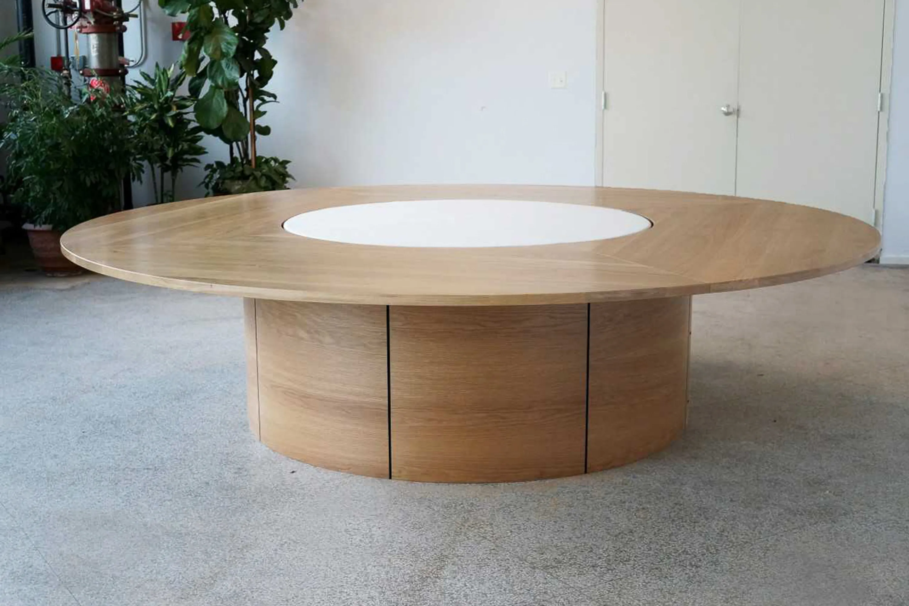 custom round conference table in oak with acoustic infill