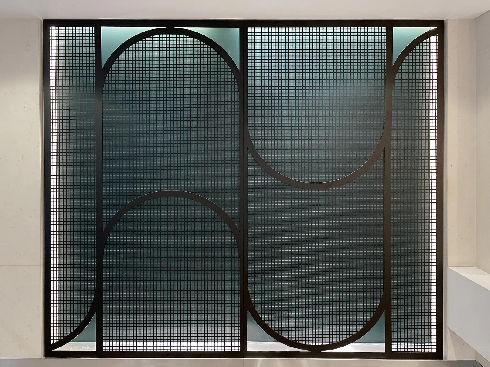 custom curved steel mesh feature wall by Icon Modern