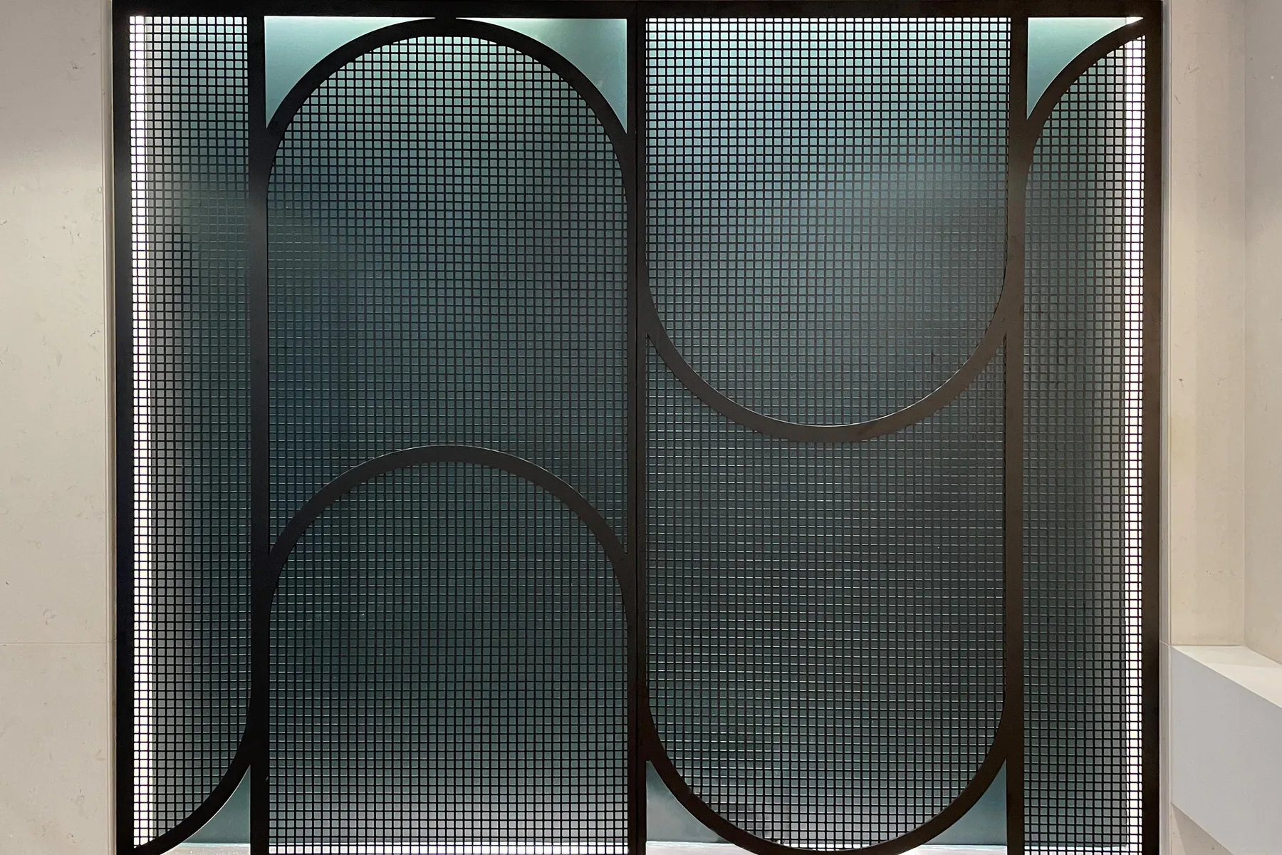 custom curved steel mesh feature wall by Icon Modern