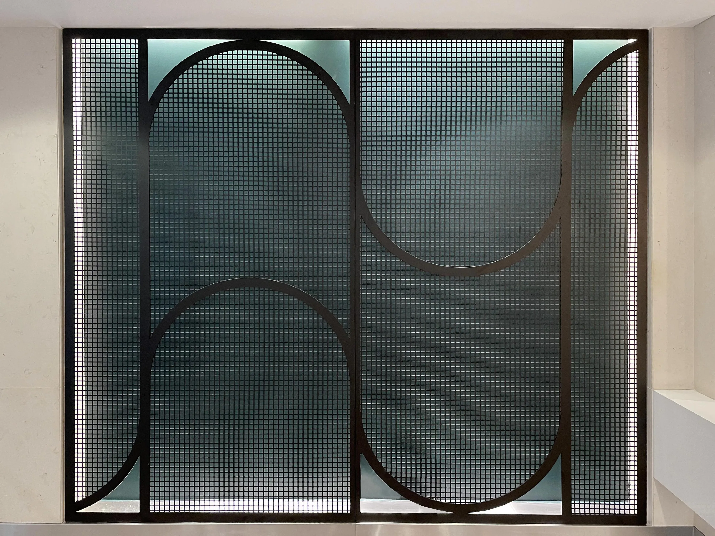 custom curved steel mesh feature wall by Icon Modern
