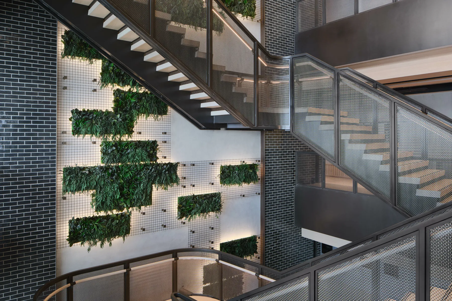 custom green wall with metal mesh panels by Icon Modern