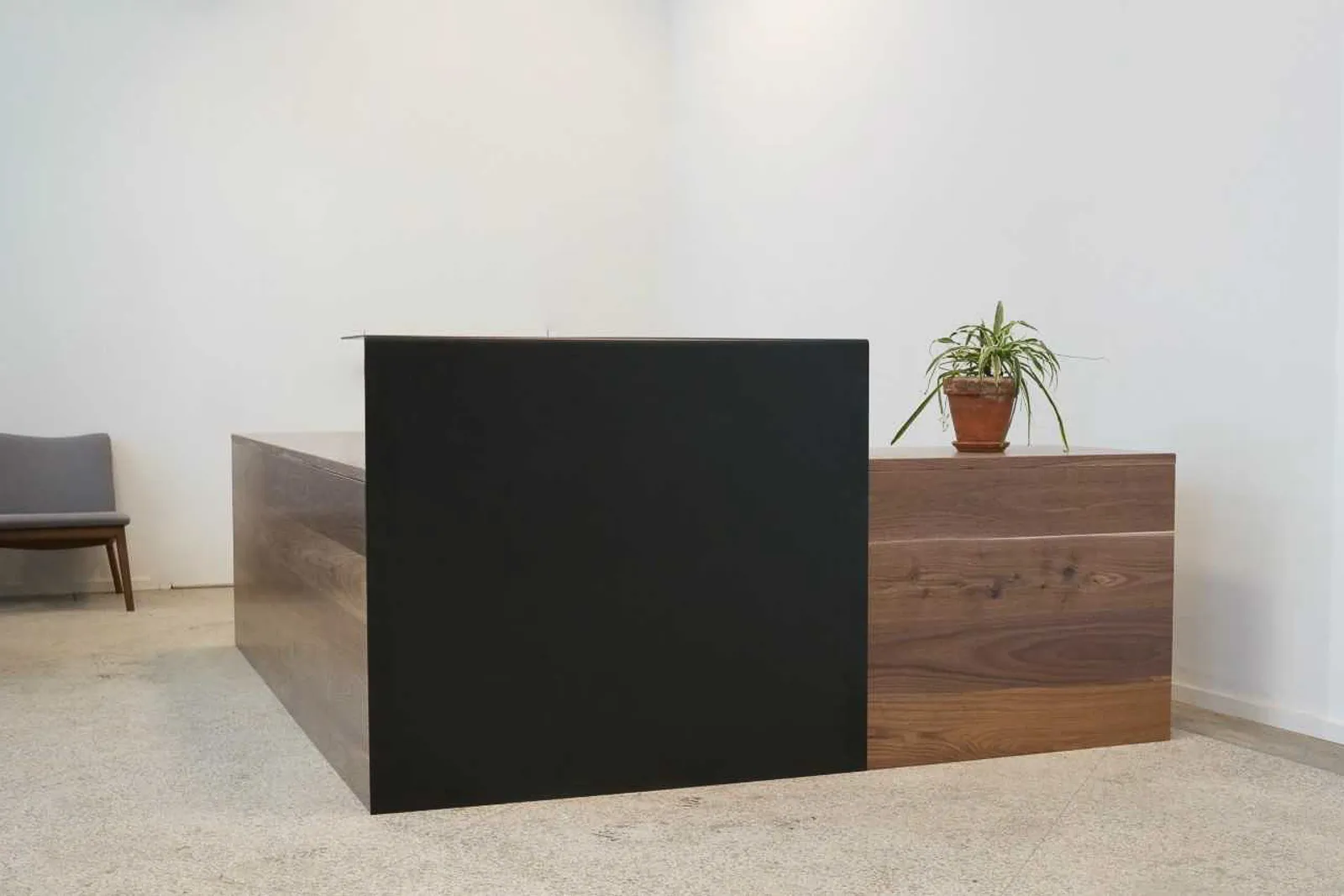 custom reception desk in urban walnut and hot rolled steel transaction element