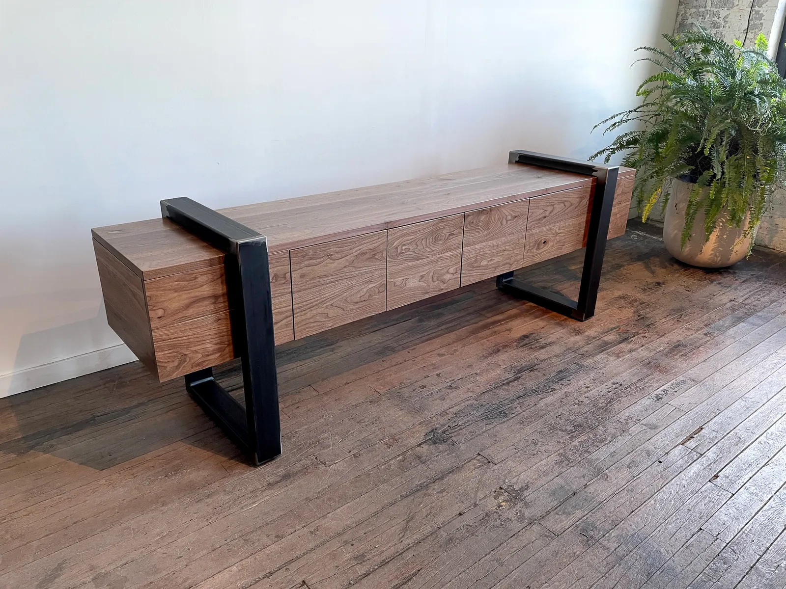 custom credenza with four doors and steel strap-style base by Icon Modern