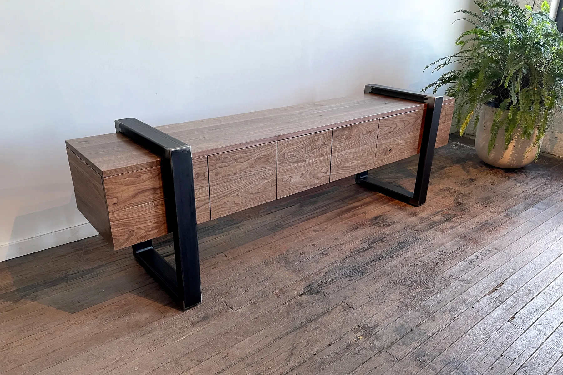 custom credenza with four doors and steel strap-style base by Icon Modern