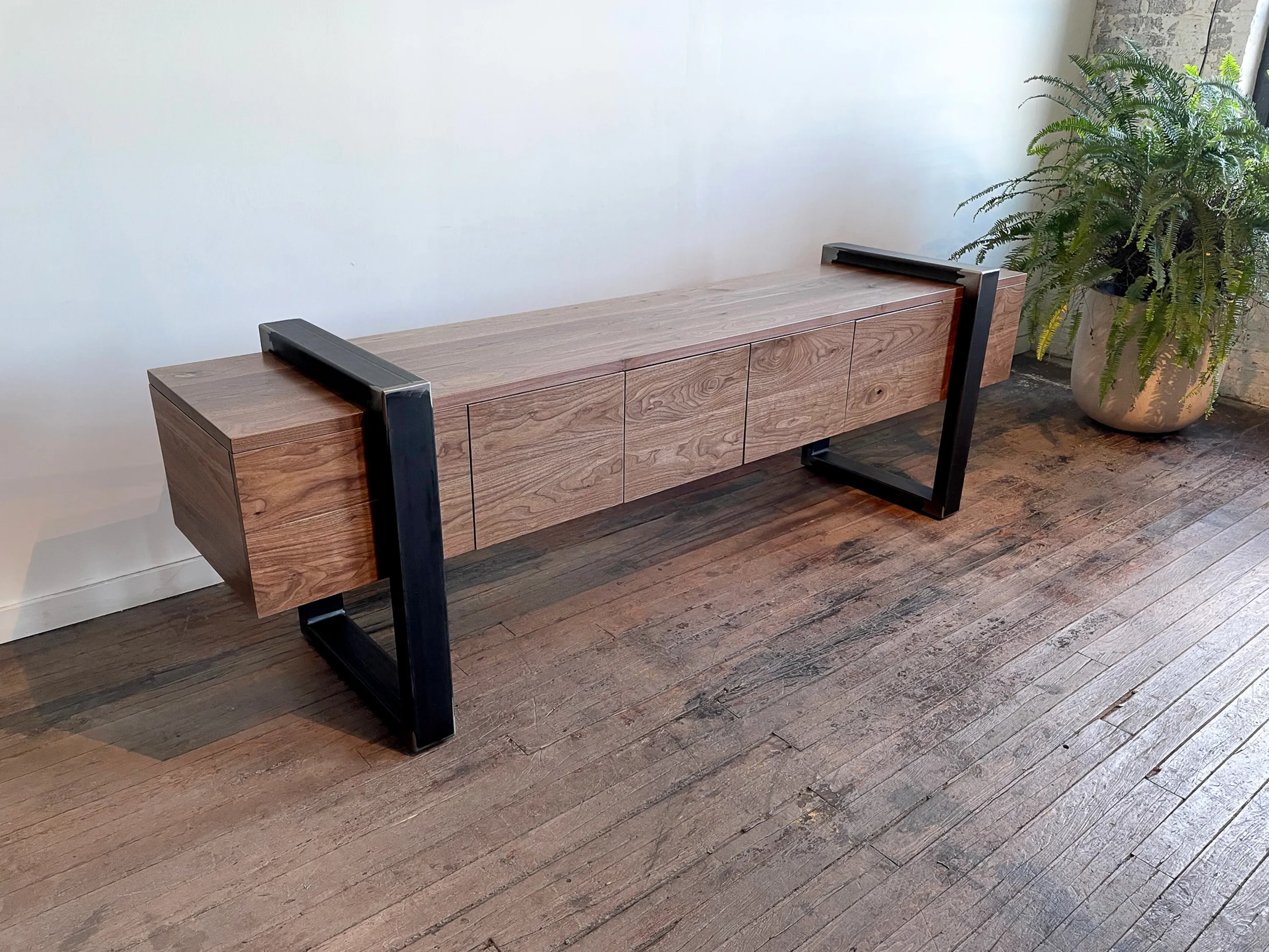 custom credenza with four doors and steel strap-style base by Icon Modern