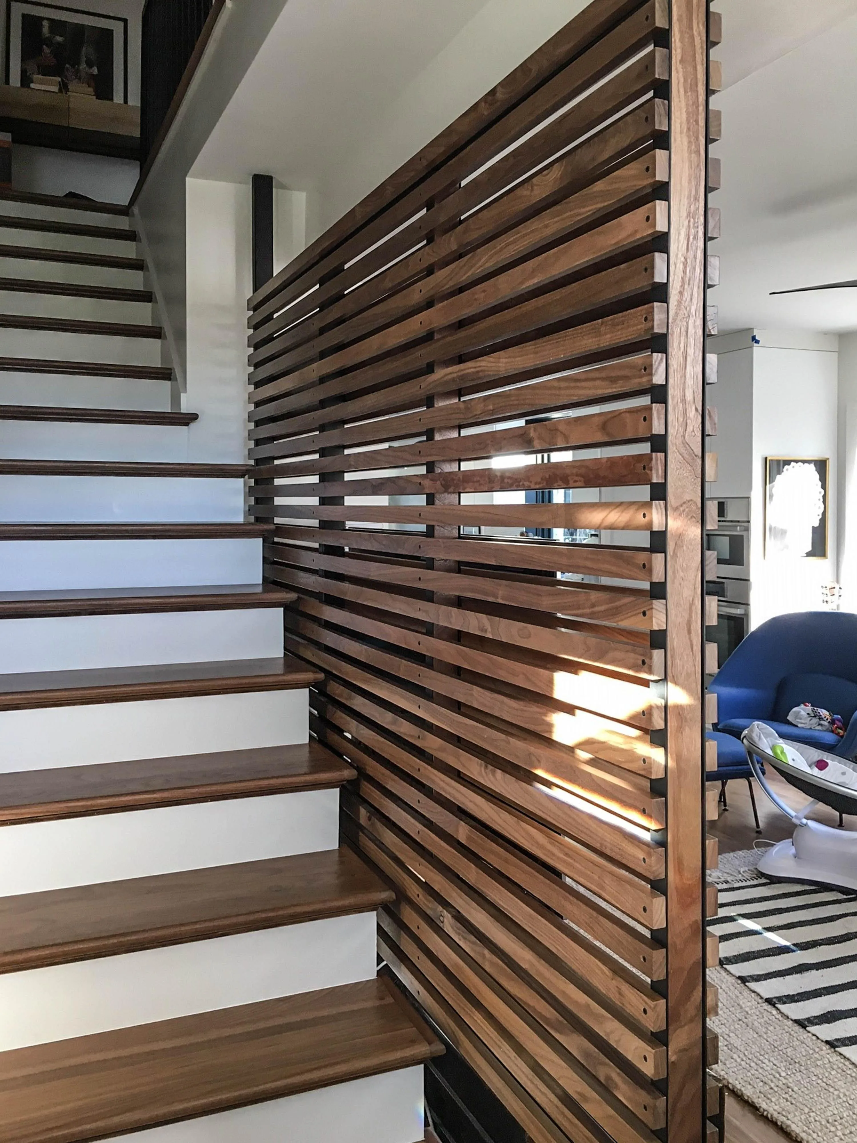 custom space divider in urban walnut slats by Icon Modern