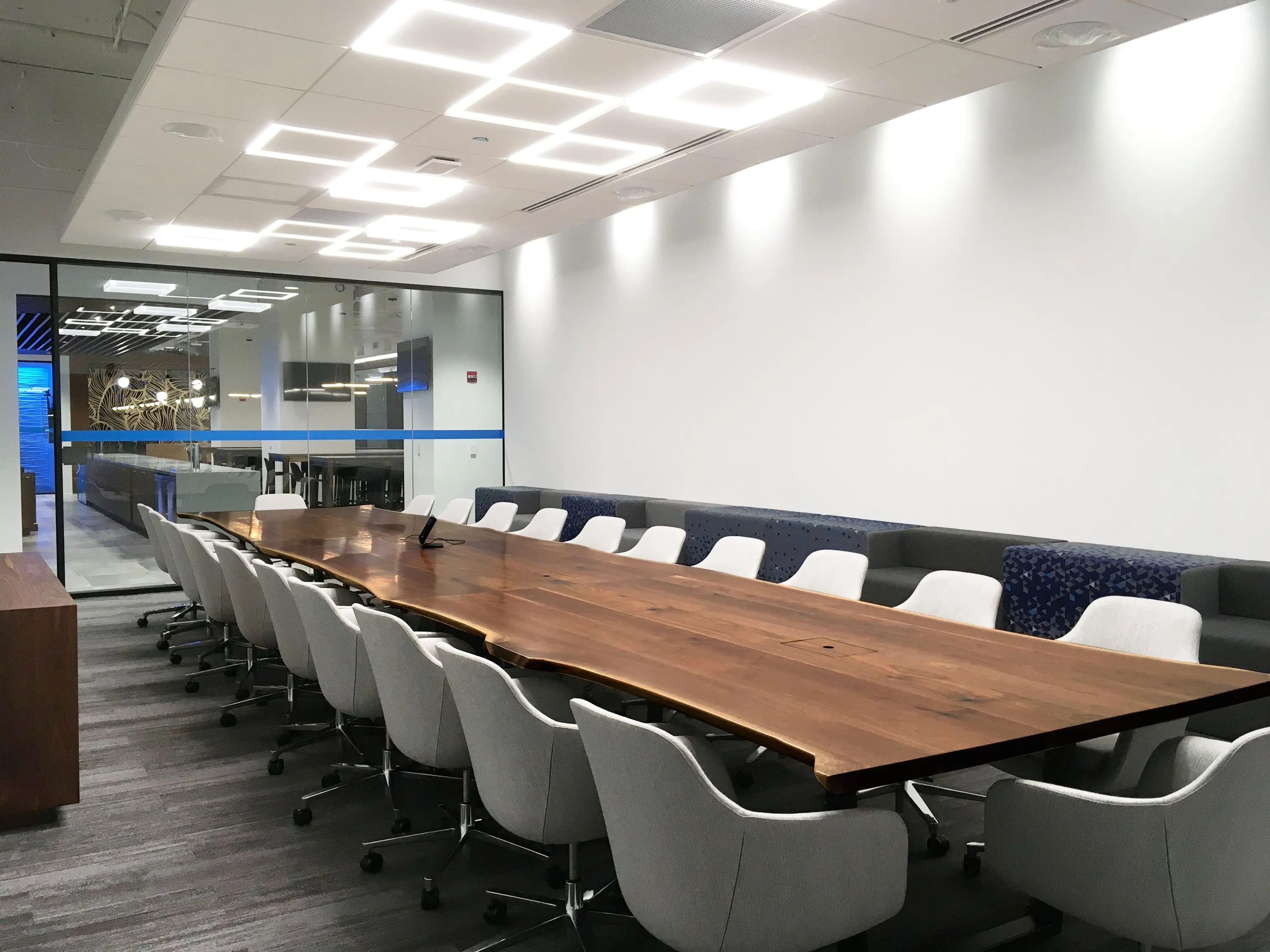 custom conference table in urban walnut live edge by Icon Modern