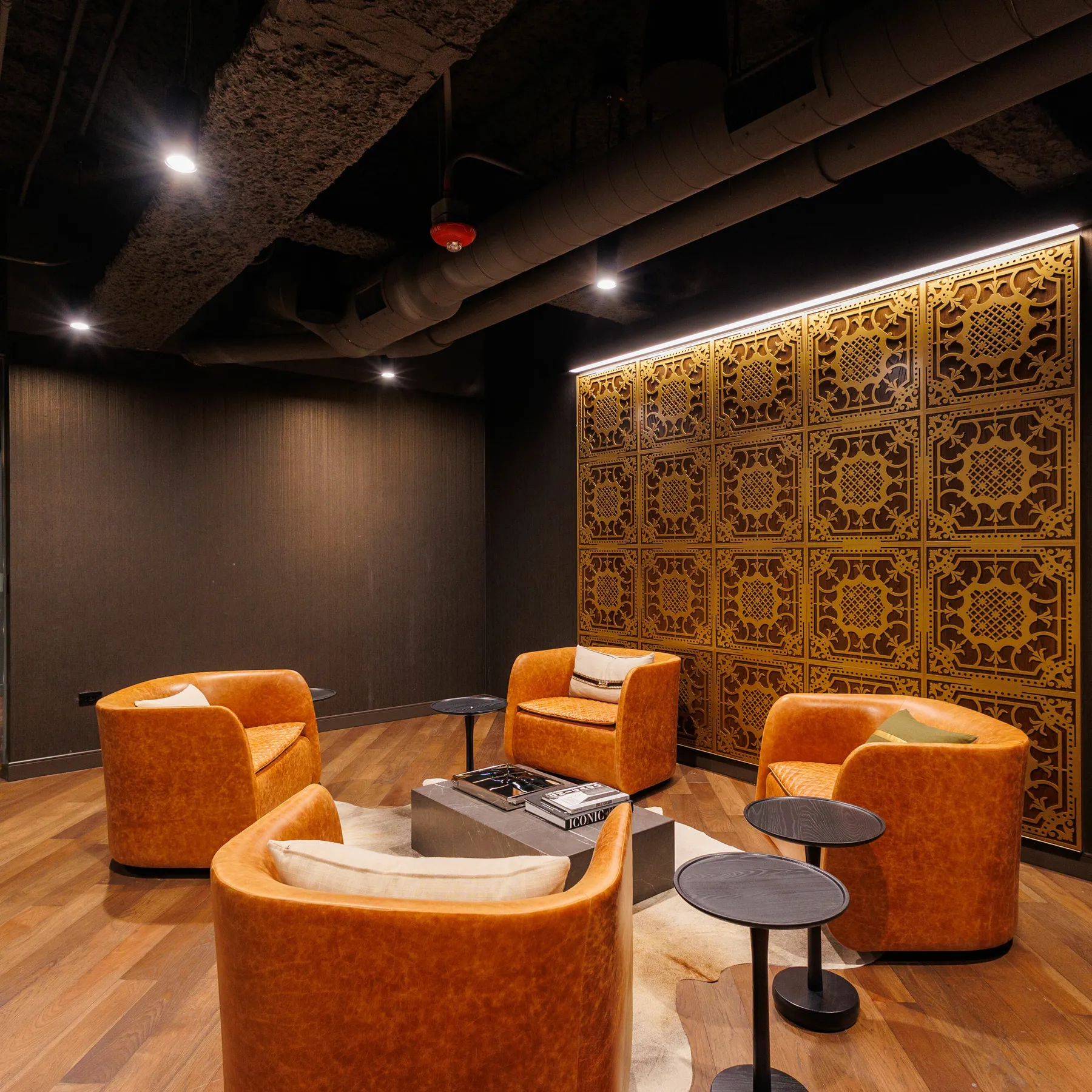 custom feature wall with laser cut steel pattern and walnut veneer backing by Icon Modern