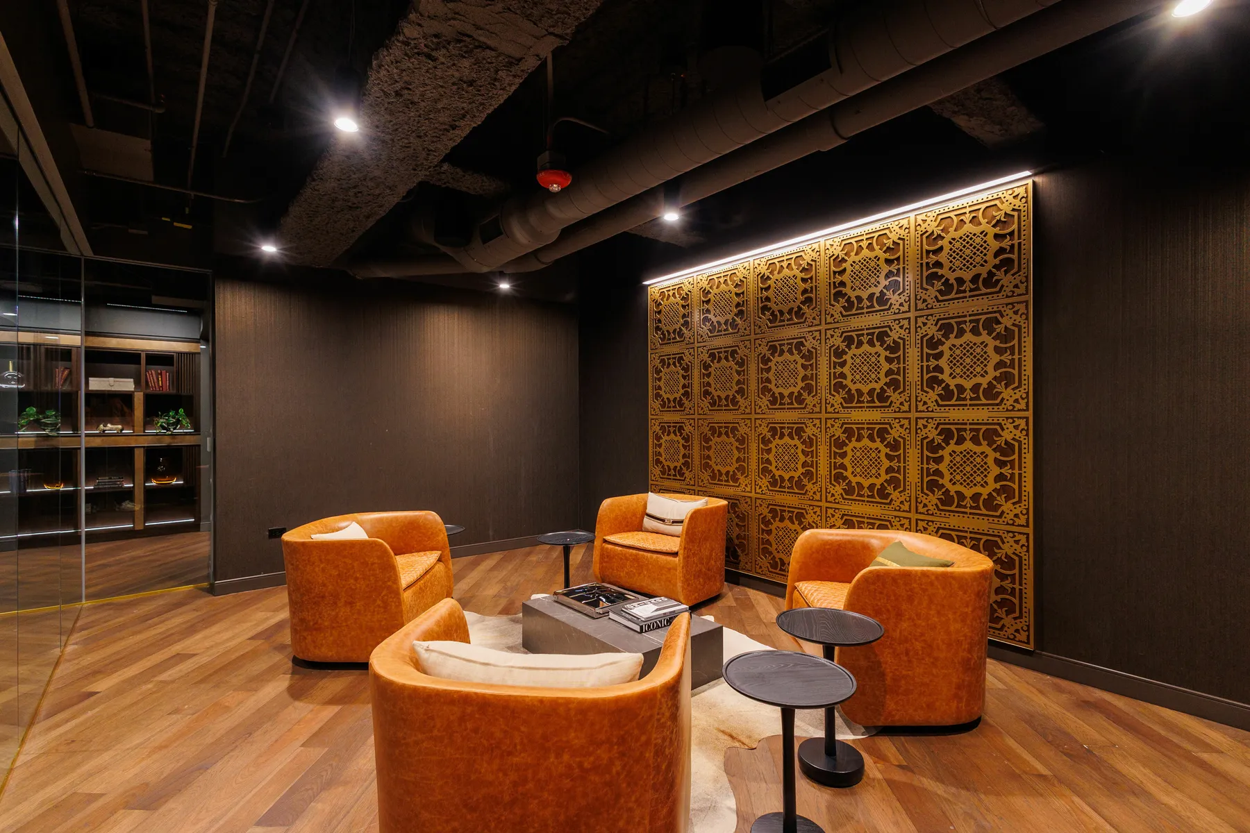 custom feature wall with laser cut steel pattern and walnut veneer backing by Icon Modern