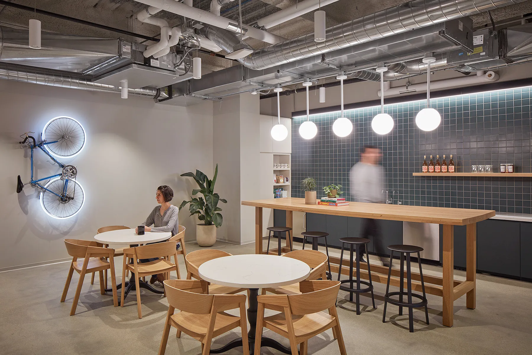 custom oak wood community table with footrest by Icon Modern