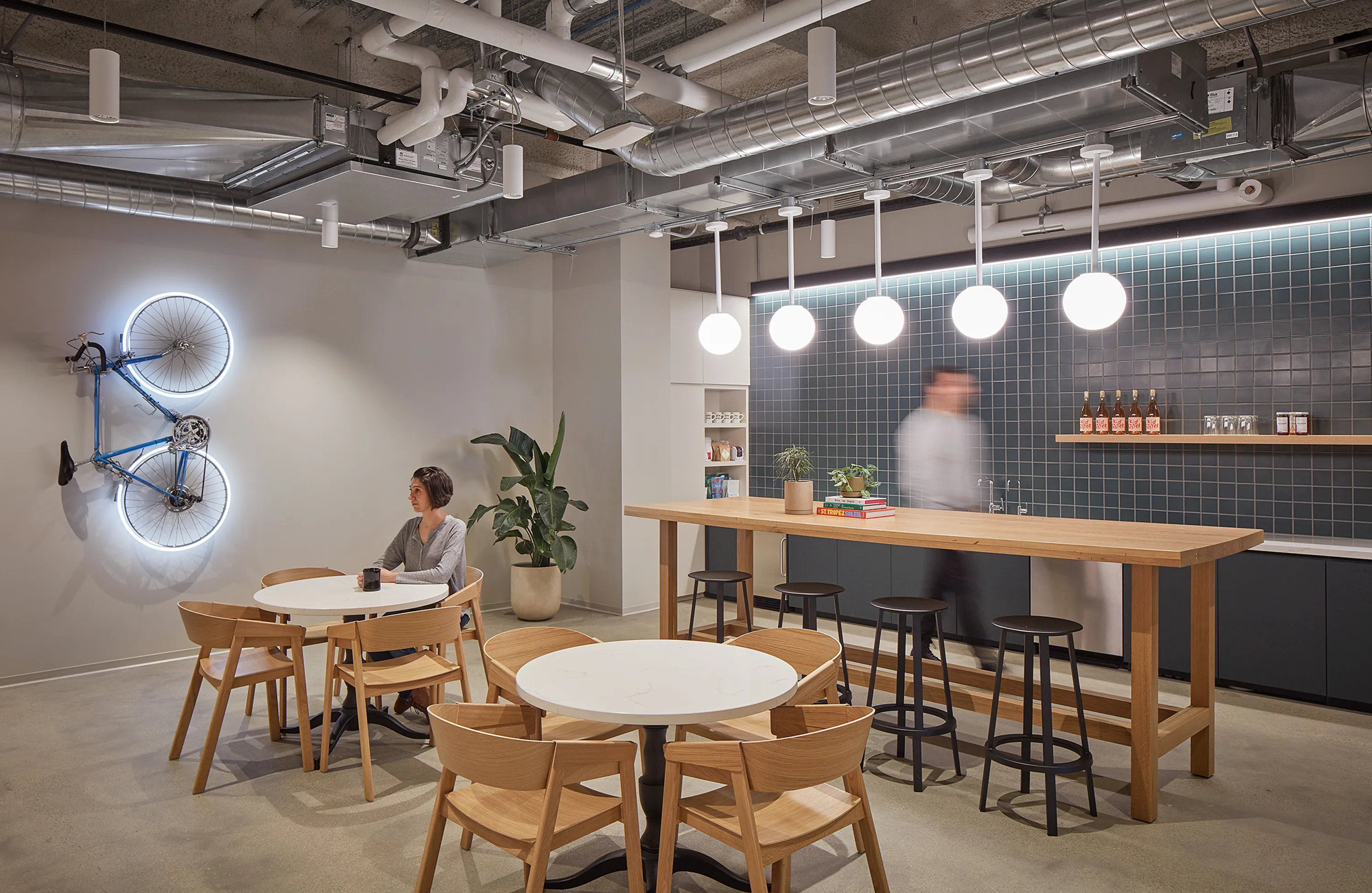 custom oak wood community table with footrest by Icon Modern