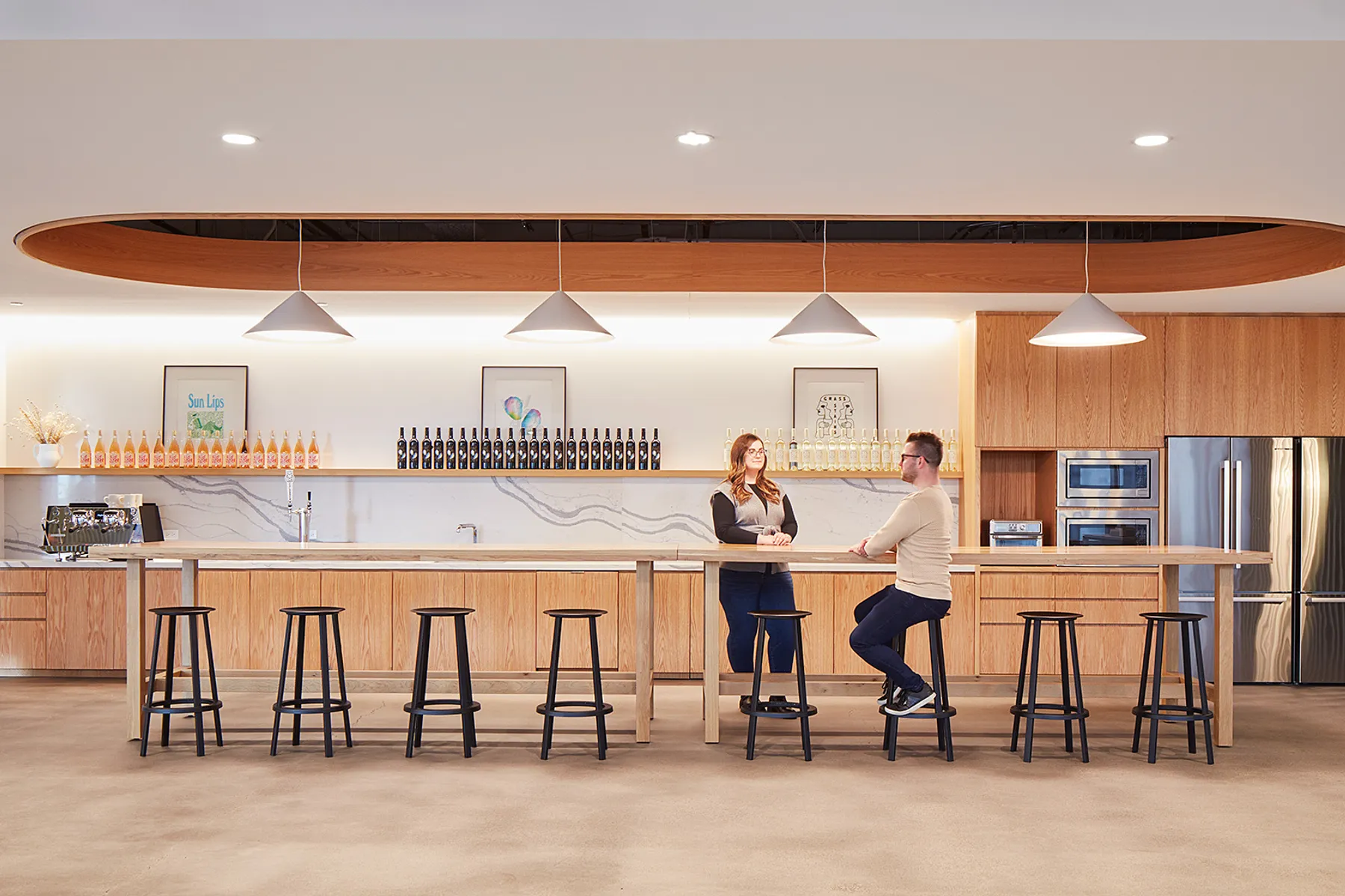 custom oak wood tables with footrests by Icon Modern