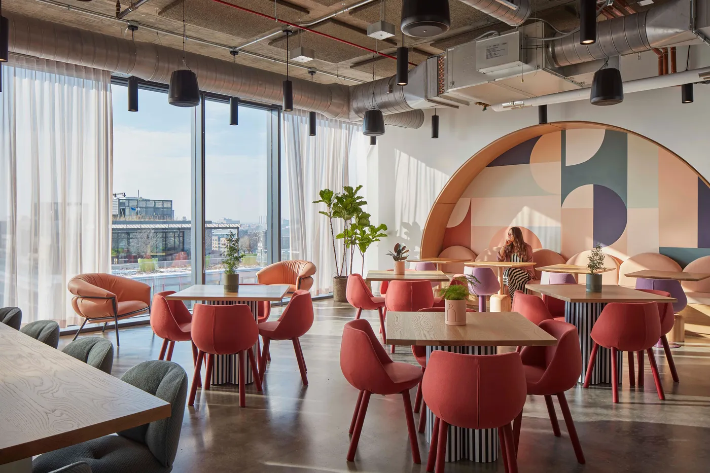 custom cafe tables in urban oak with custom painted drum bases by Icon Modern