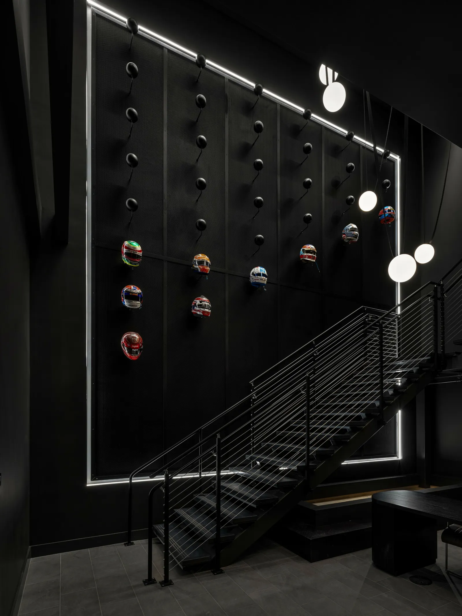 custom branded feature wall in steel with helmets by Icon Modern