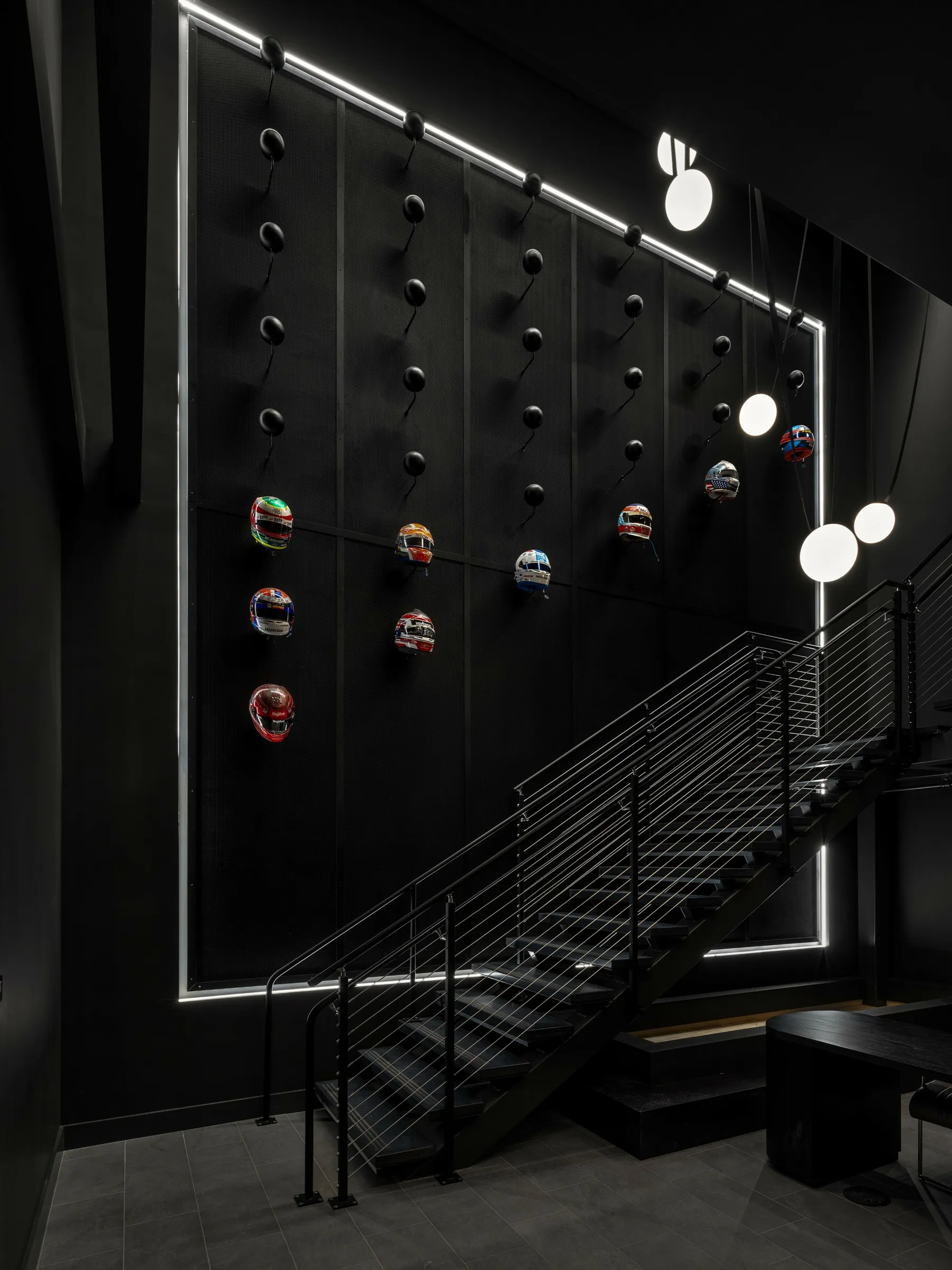 custom branded feature wall in steel with helmets by Icon Modern