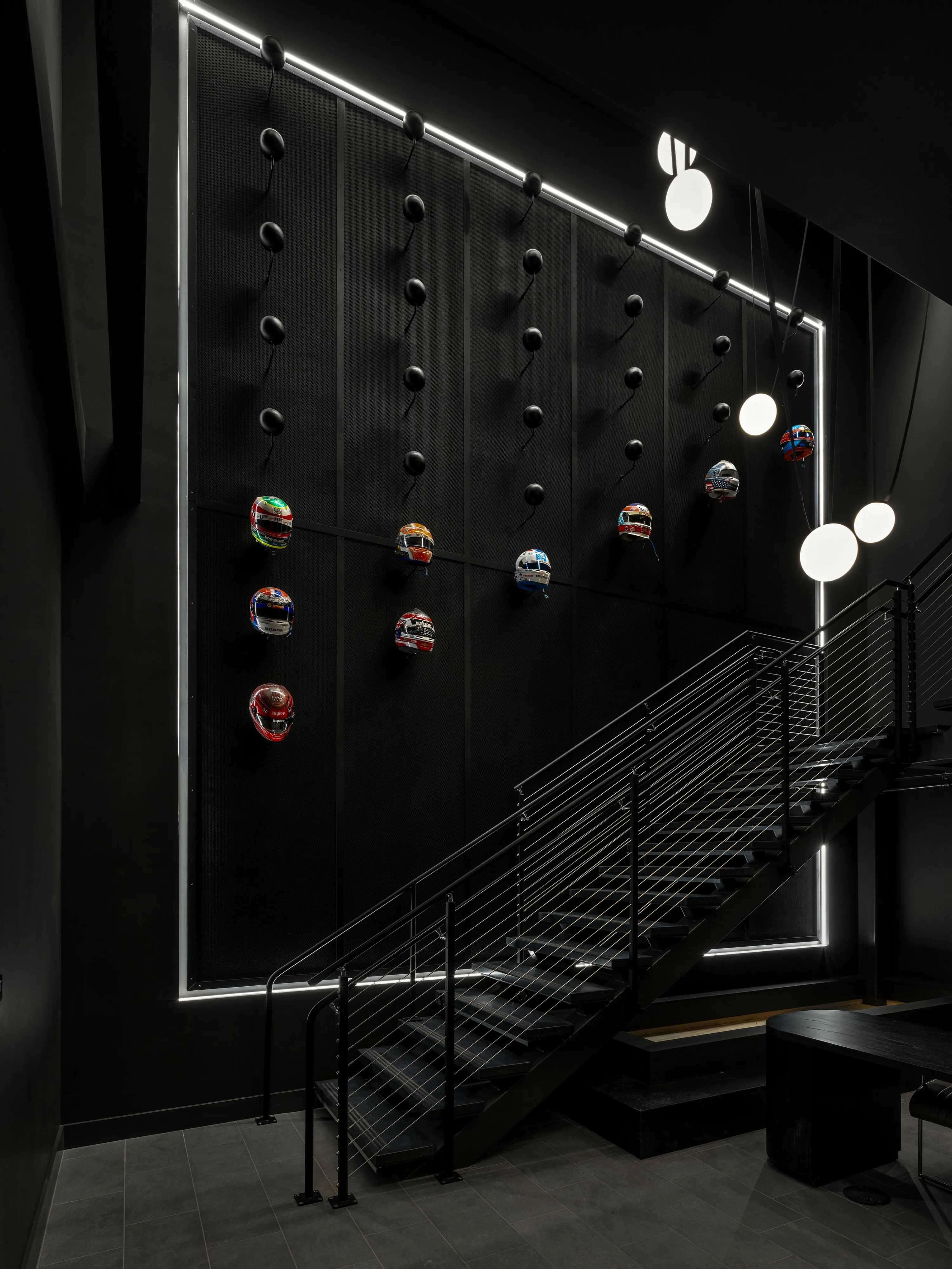 custom branded feature wall in steel with helmets by Icon Modern