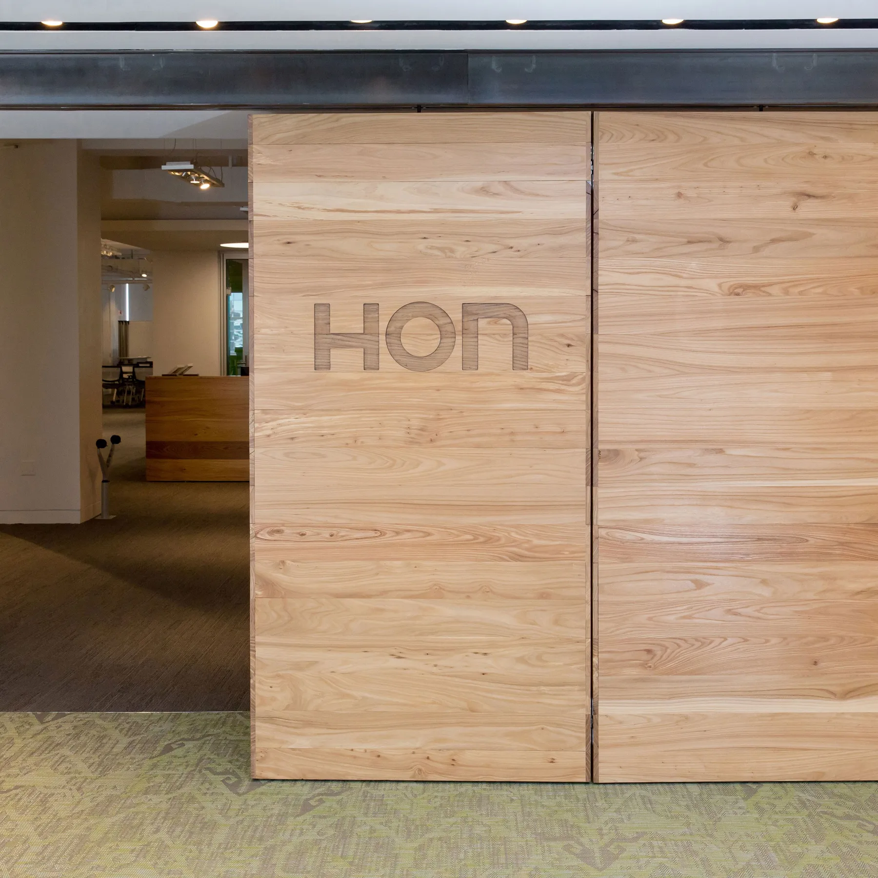 custom door in urban elm with CNC branding by Icon Modern