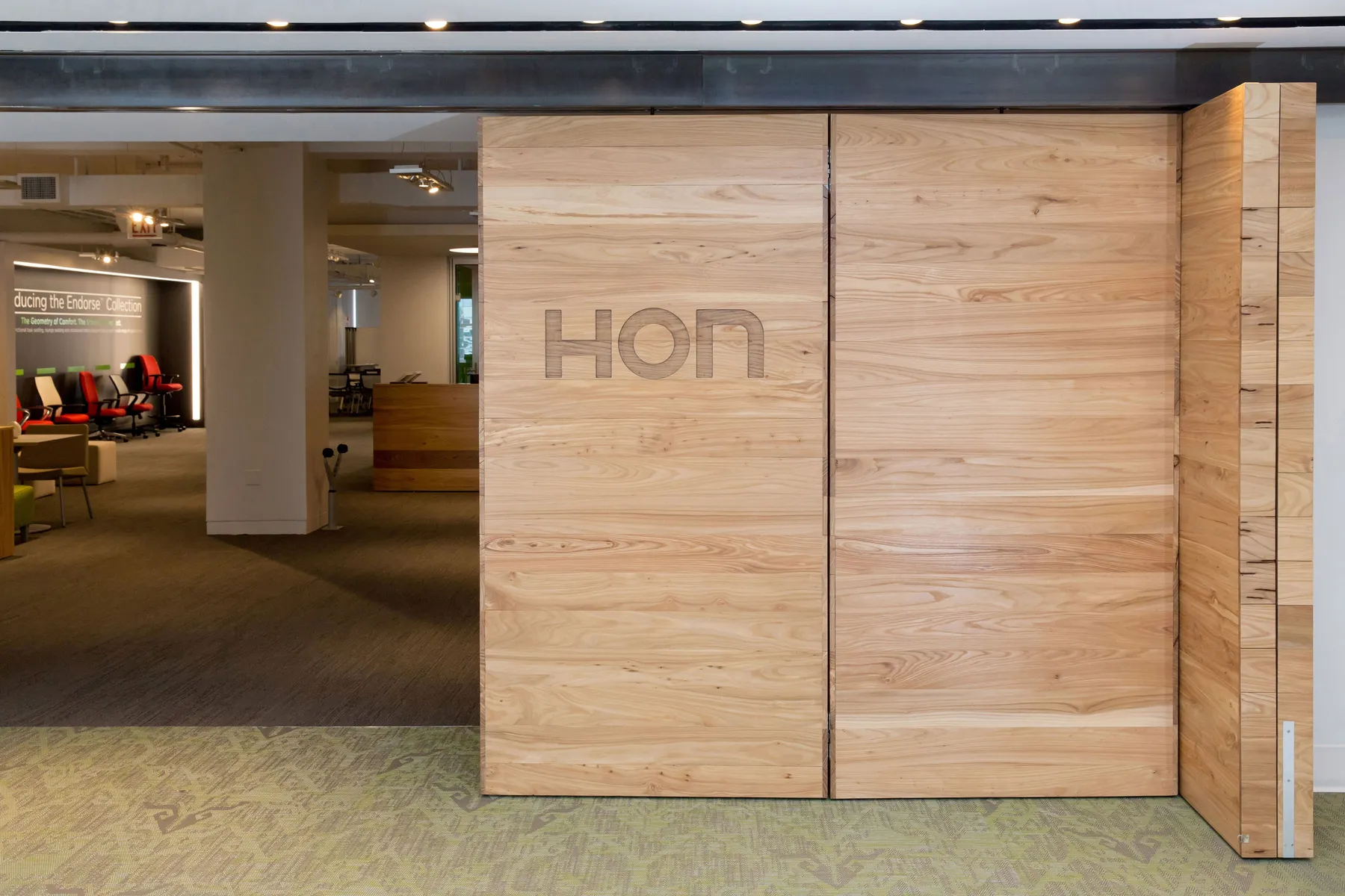 custom door in urban elm with CNC branding by Icon Modern