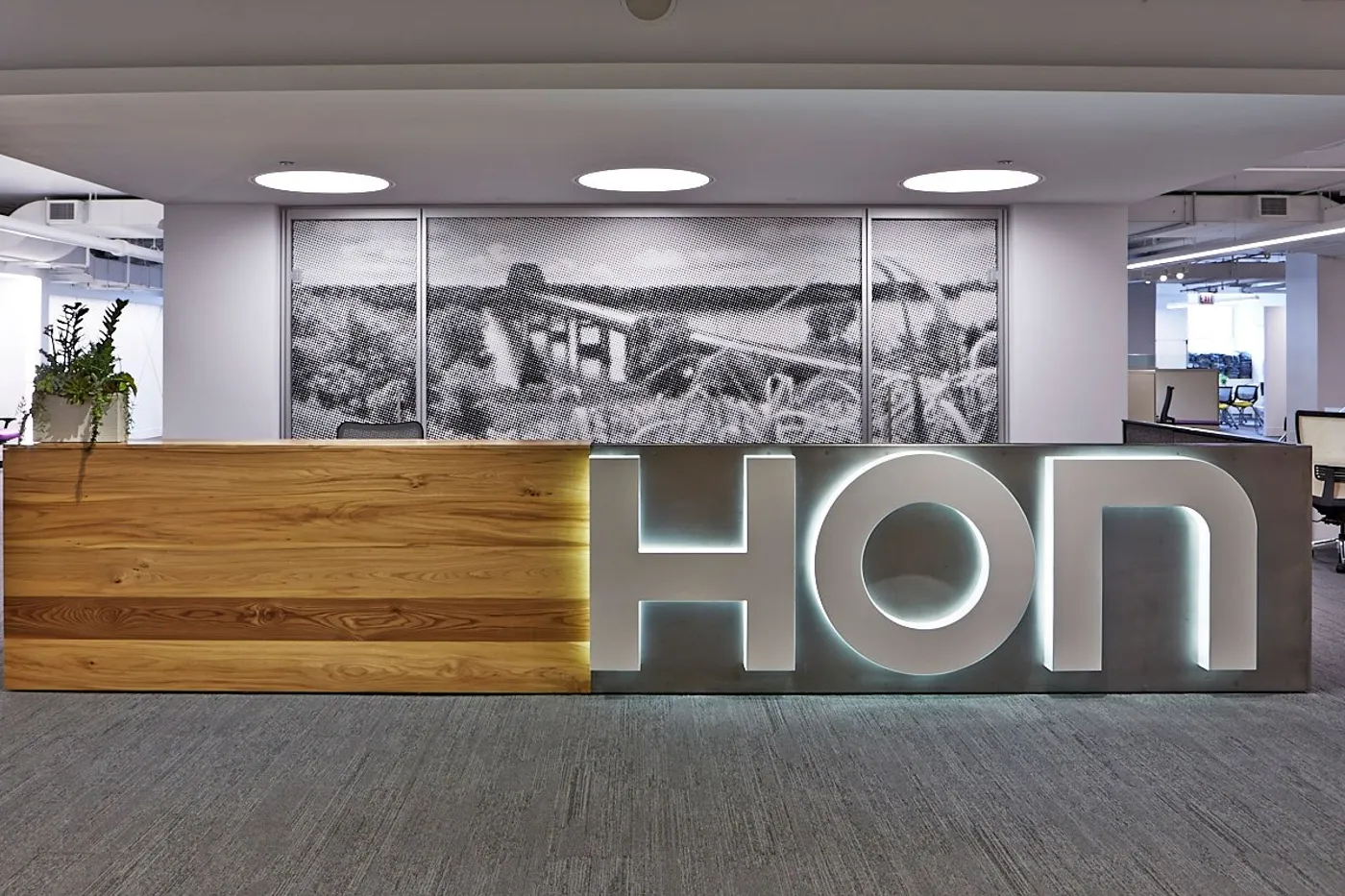 custom reception desk in urban elm with steel panel by Icon Modern