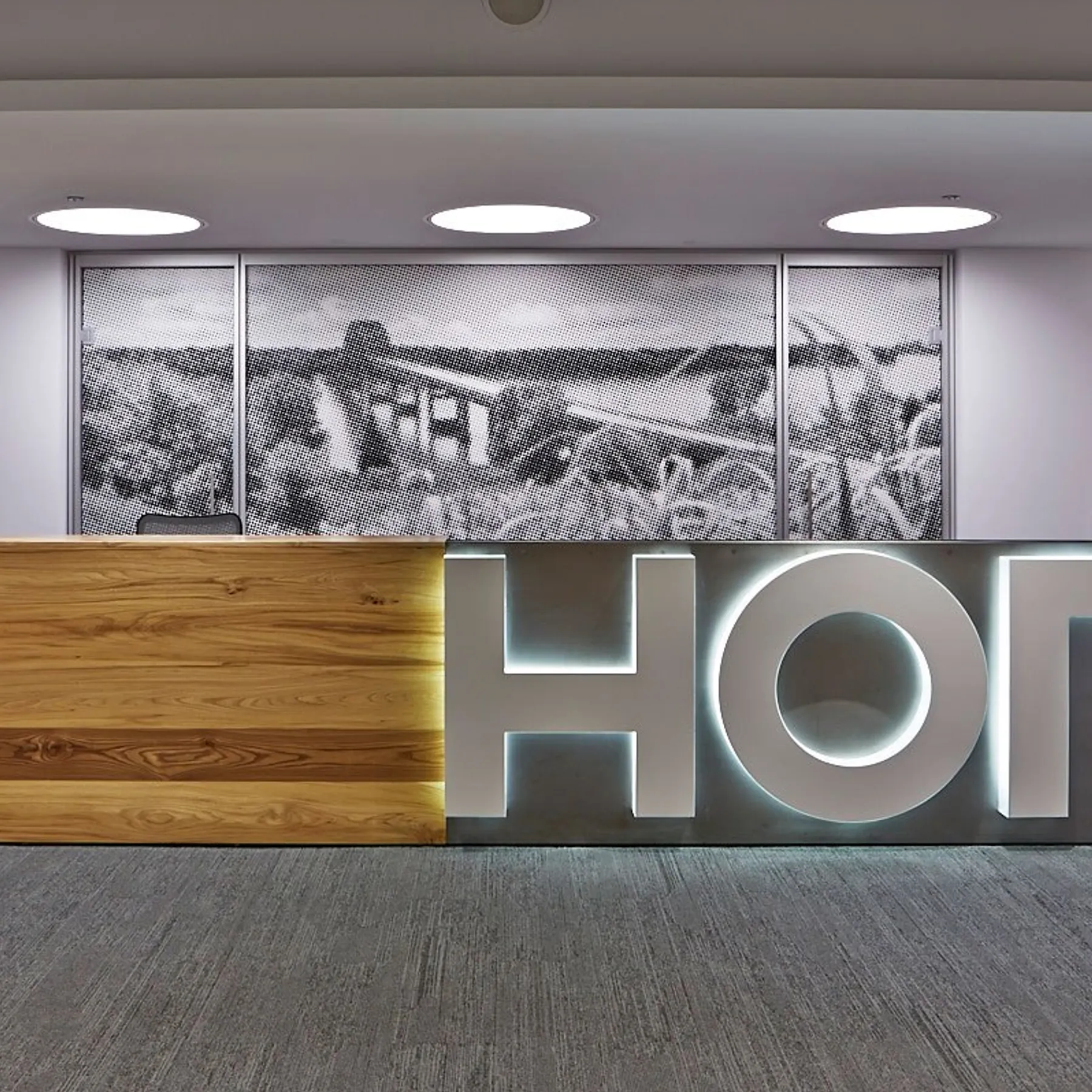 custom reception desk in urban elm with steel panel by Icon Modern