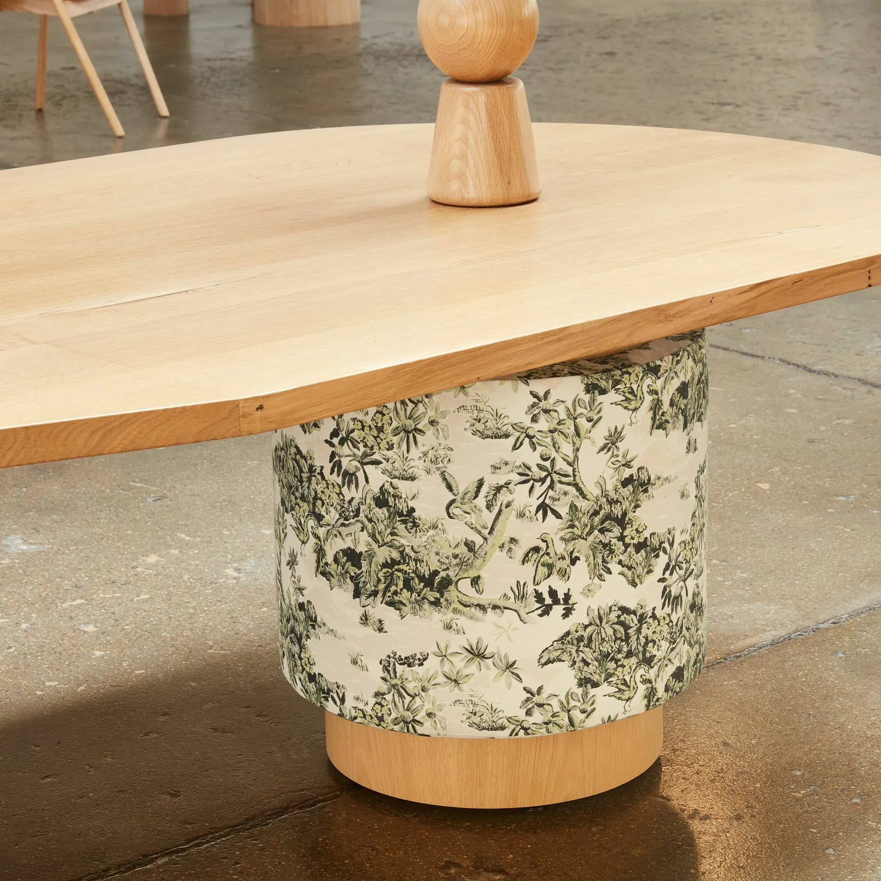 custom table with fabric-wrapped drum base by Icon Modern
