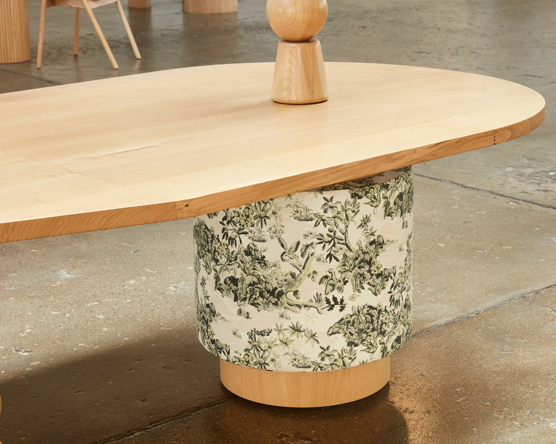 custom table with fabric-wrapped drum base by Icon Modern