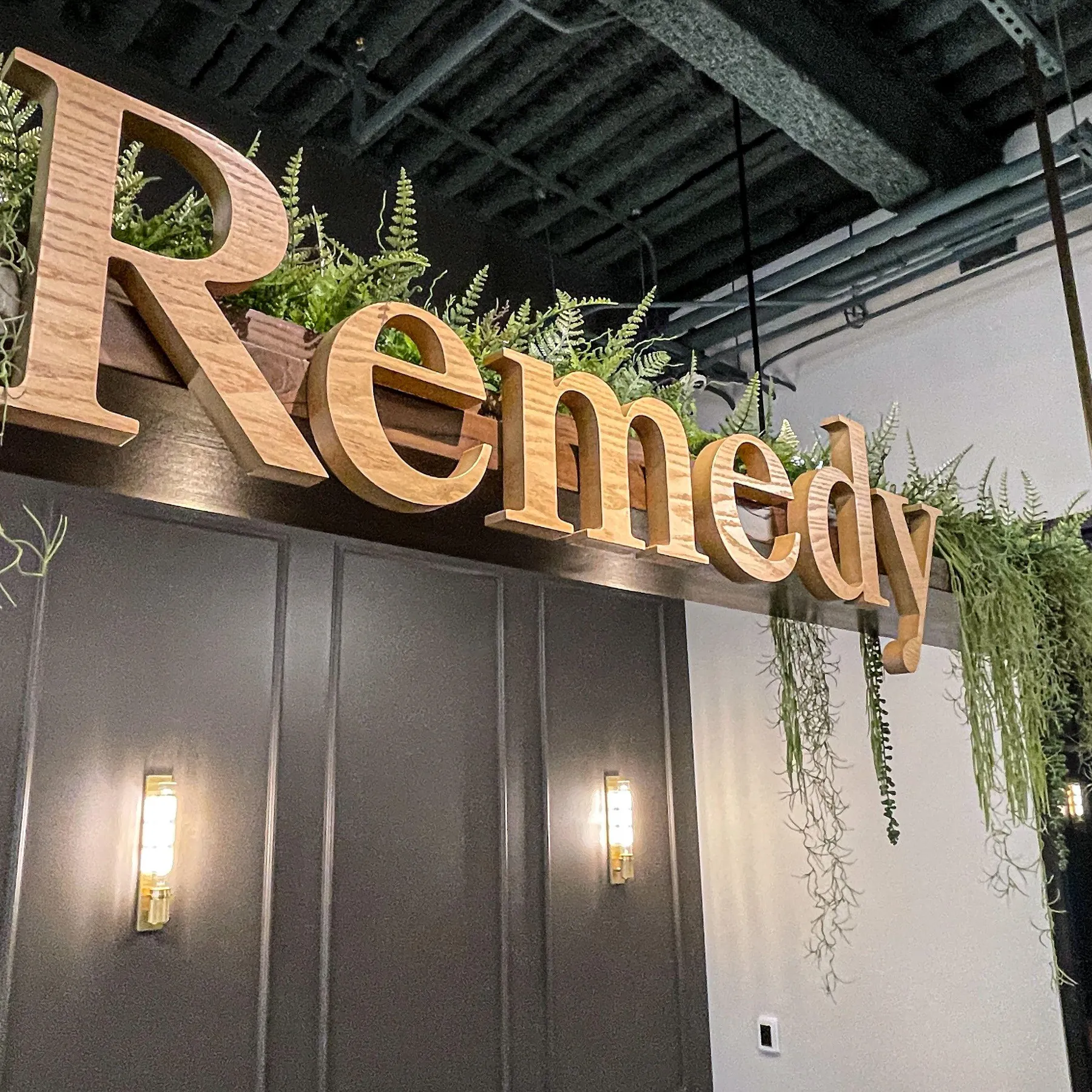 custom signage and and hanging planter by Icon Modern