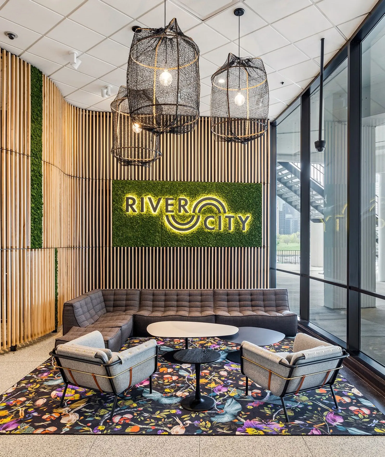 custom branding with laser cut steel and ash slat wall with plants by Icon Modern