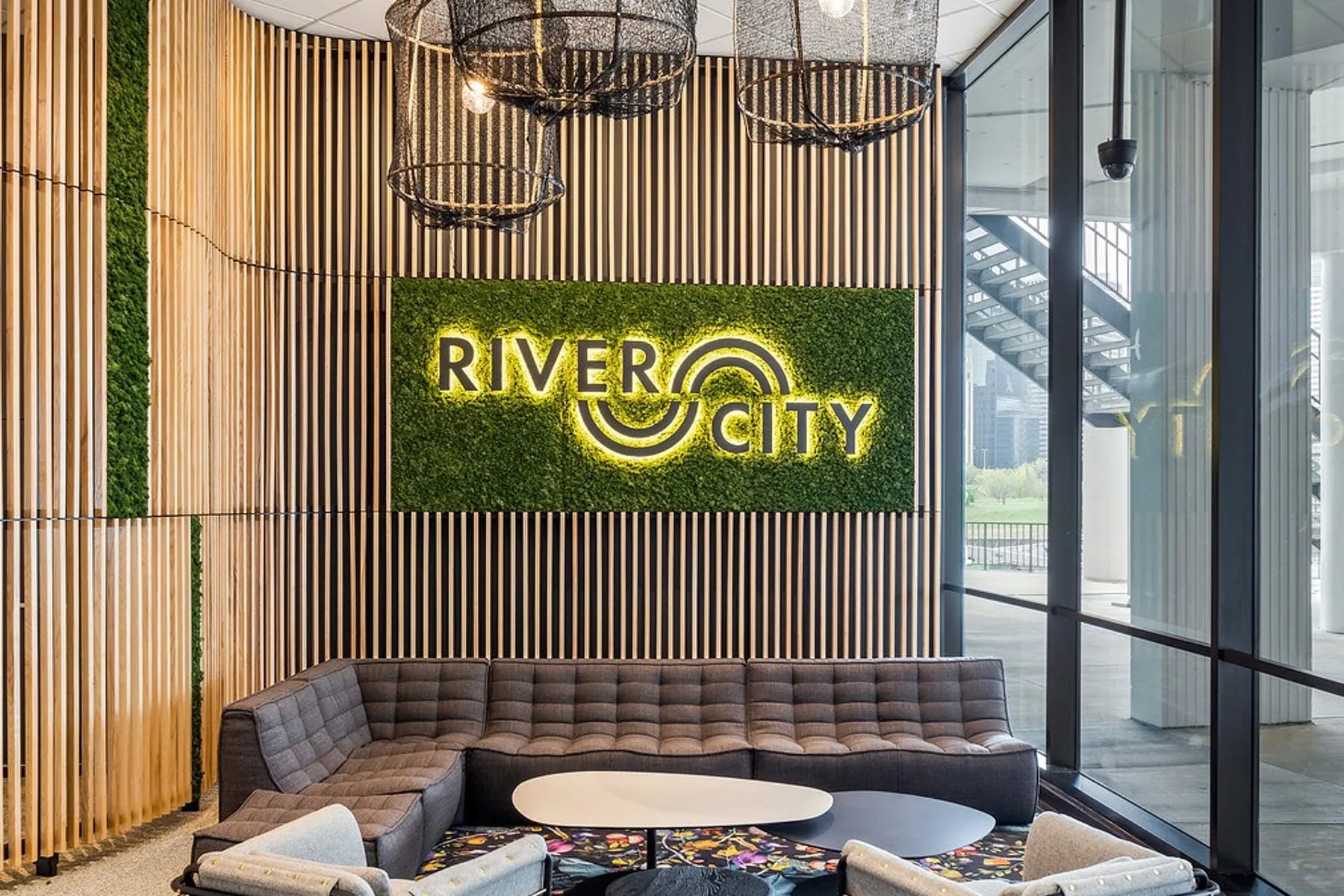 custom branding with laser cut steel and ash slat wall with plants by Icon Modern