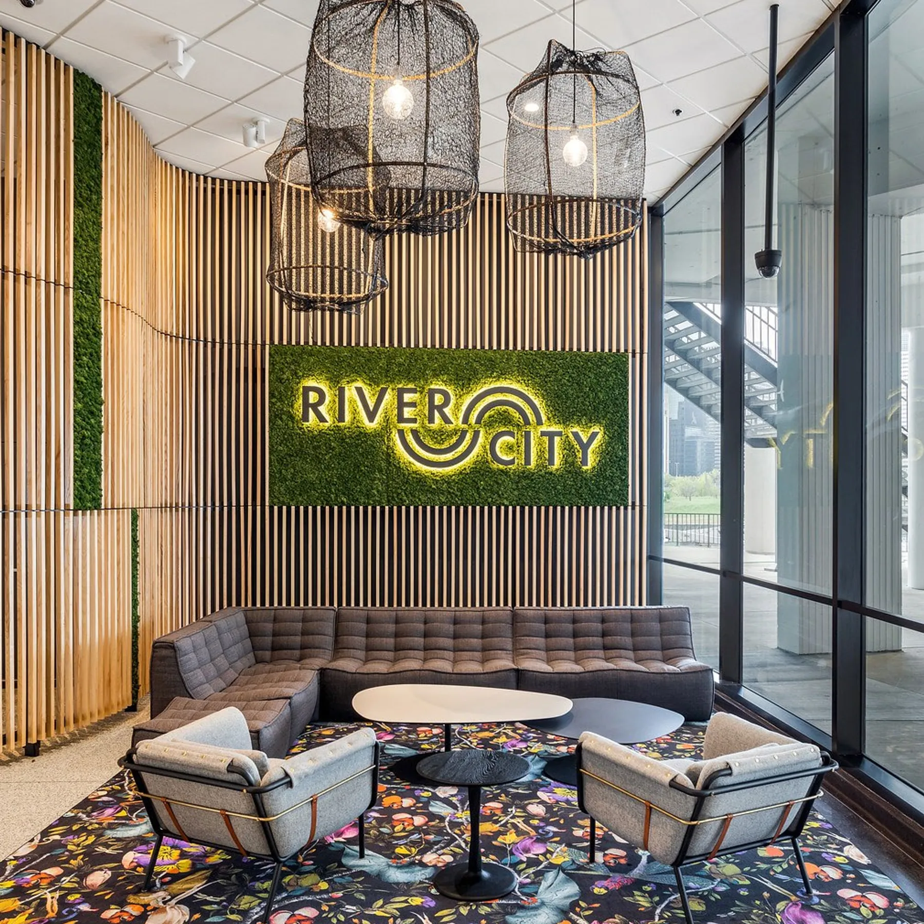 custom branding with laser cut steel and ash slat wall with plants by Icon Modern